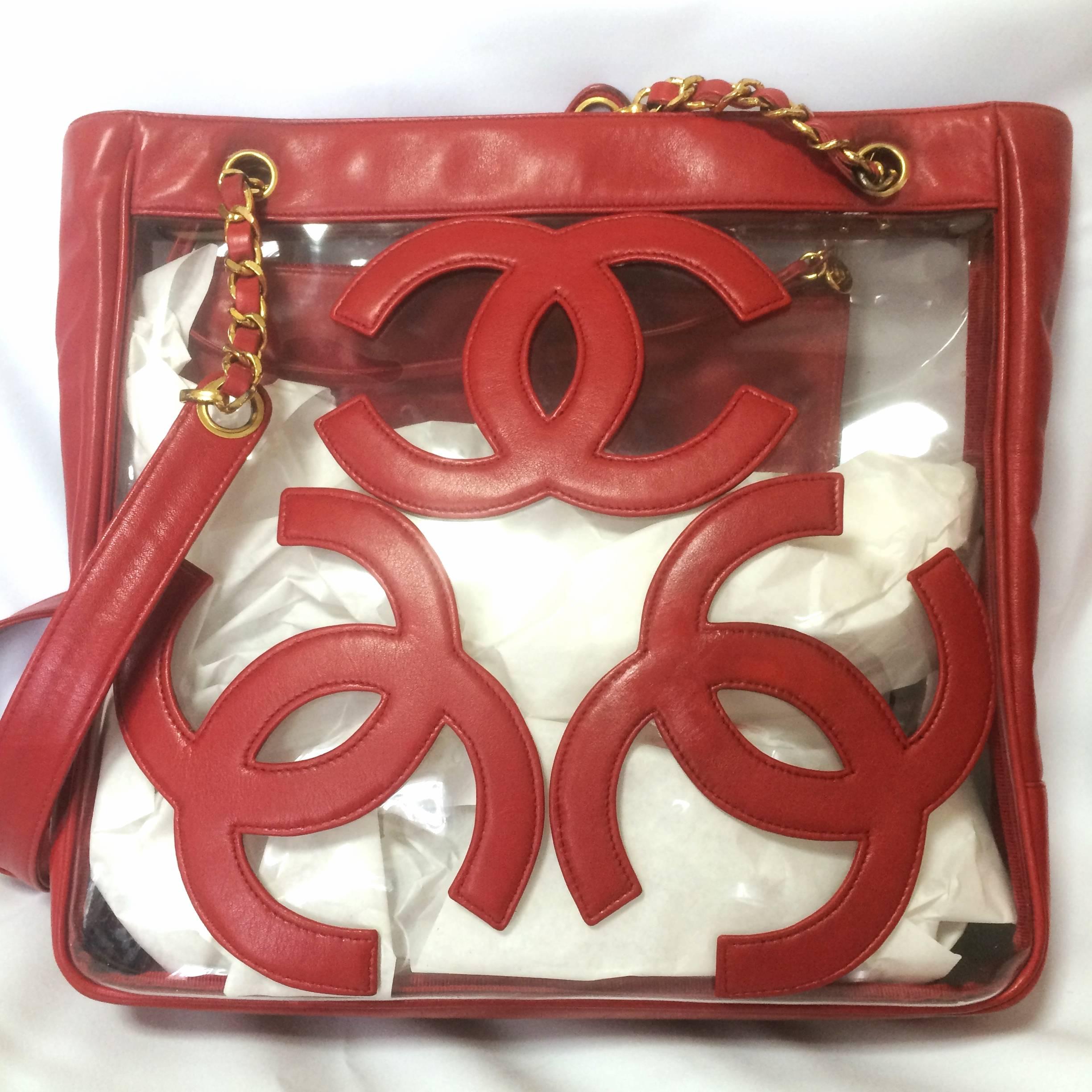 1990s.Vintage CHANEL clear vinyl and red leather combination shoulder purse, tote with CC marks and matching pouch. Golden chain.

****The navy version is also on sale! ****

If you are looking for a vintage CHANEL in classic style but something a