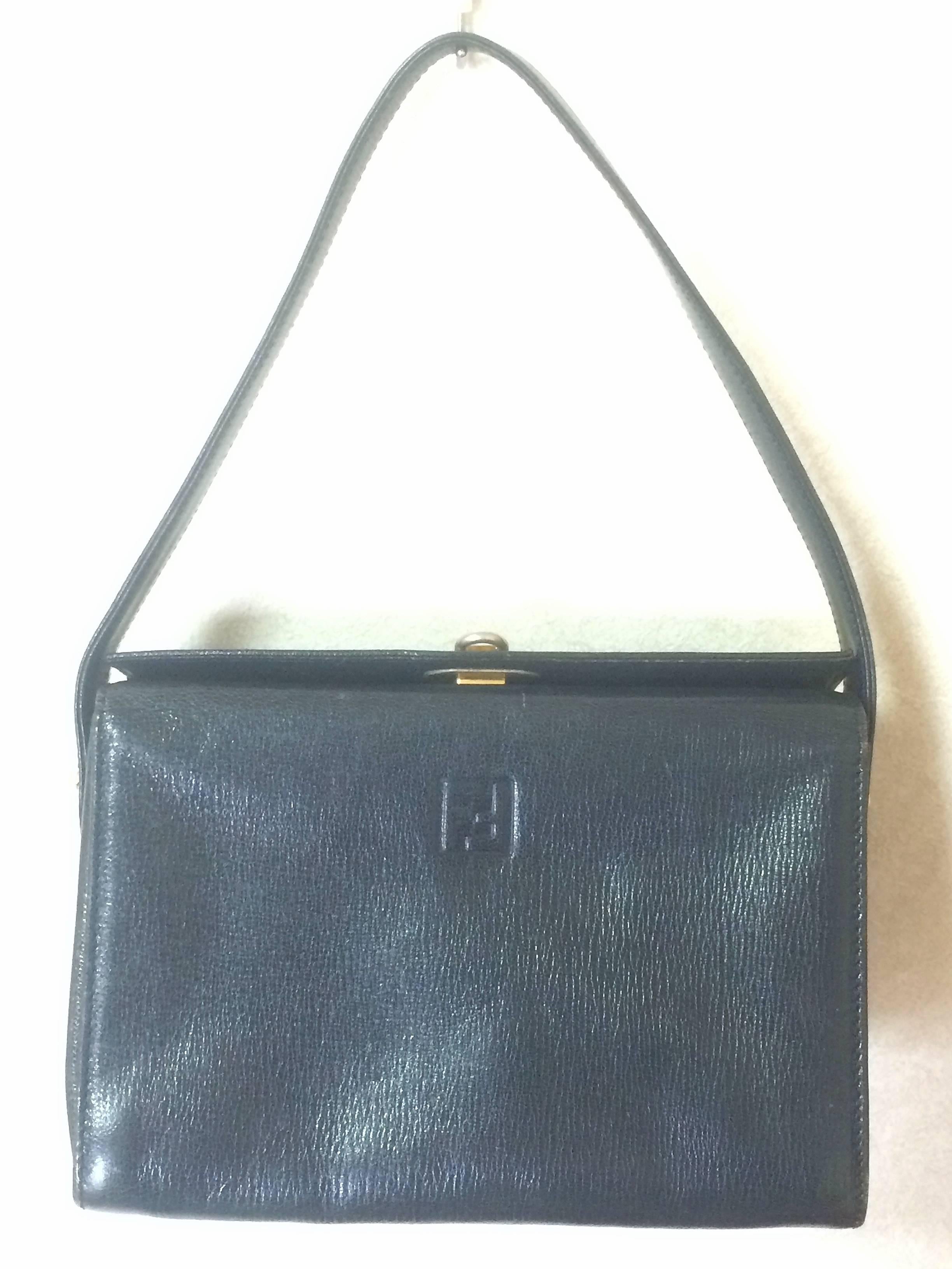 1980s. Vintage FENDI genuine navy leather square and triangle shape handbag with embossed FF logo at front and closure on top. Rare masterpiece

Introducing another masterpiece leather bag from FENDI in square and triangle shape from the old era