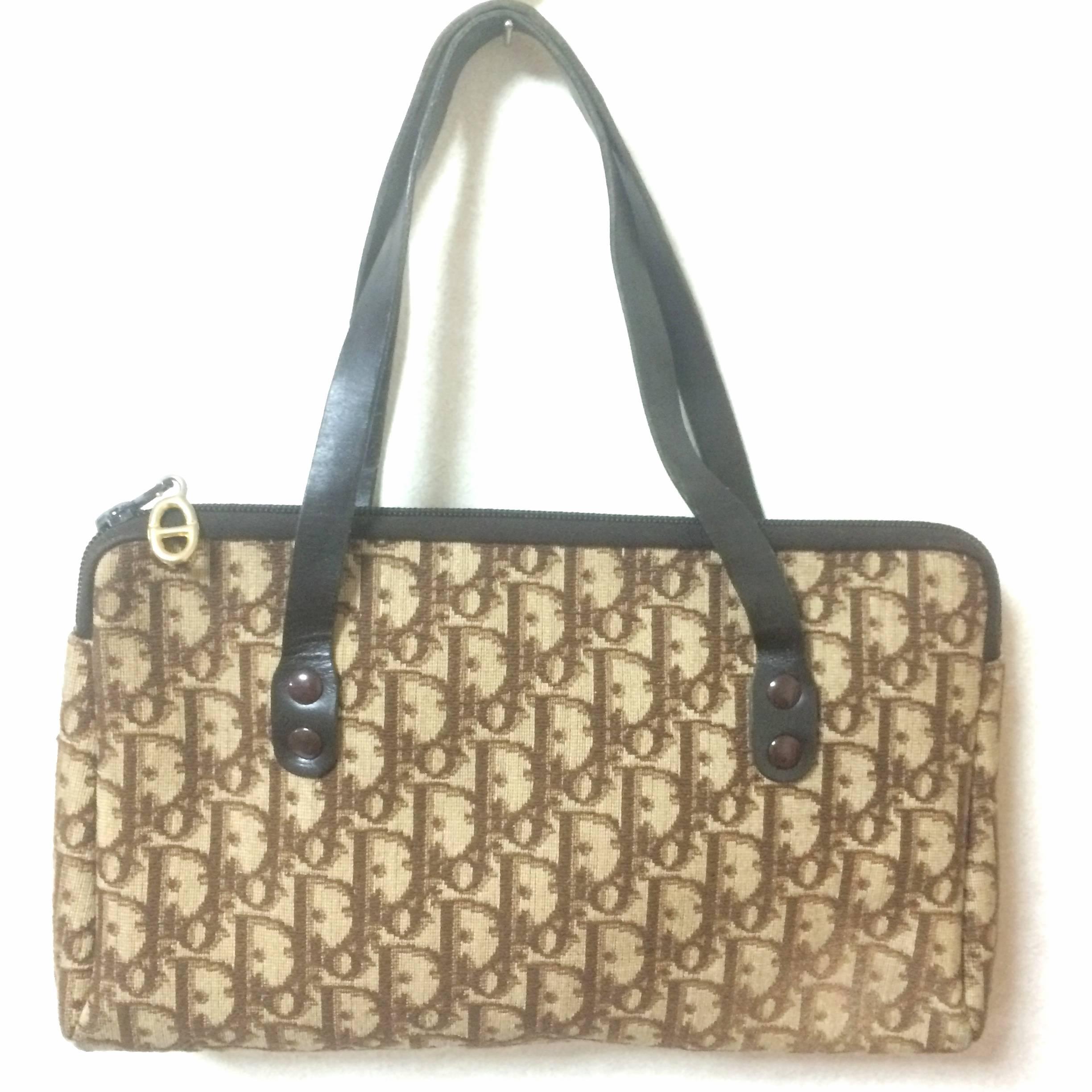 1980s. Vintage Christian Dior brown trotter jacquard mini handbag with leather handles.

This is a vintage piece from Christian Dior approx from 70-80s. 
The rough woven jacquard will make you feel its warmness and atmosphere back in the old era.
