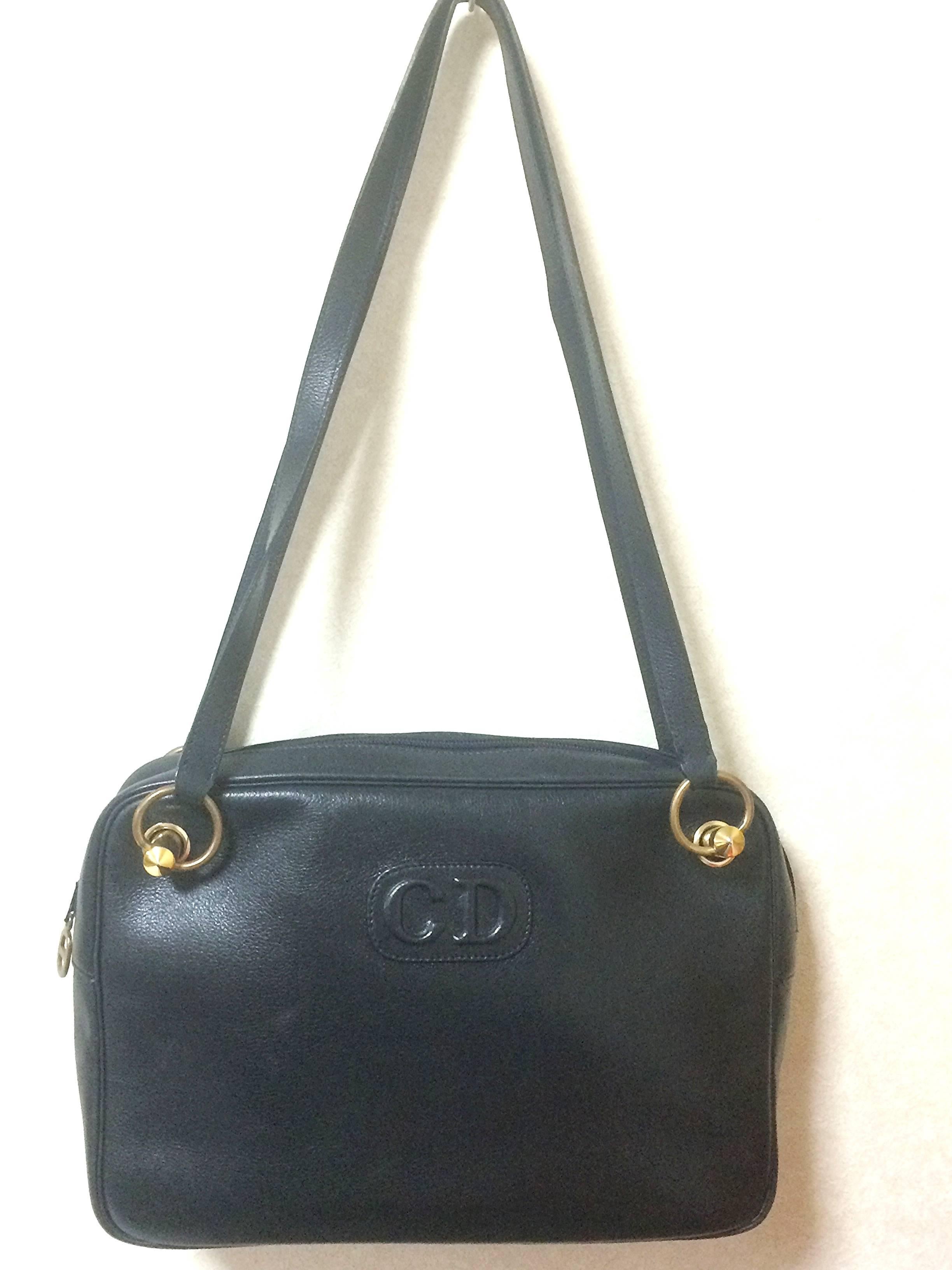 1980s. Vintage Christian Dior navy leather shoulder bag with CD embossed motif and golden brass. Masterpiece from MODELE EXCLUSIF. Unisex daily bag.

This is a  Christian Dior navy leather shoulder bag from 80's.
Masterpiece from "MODELE