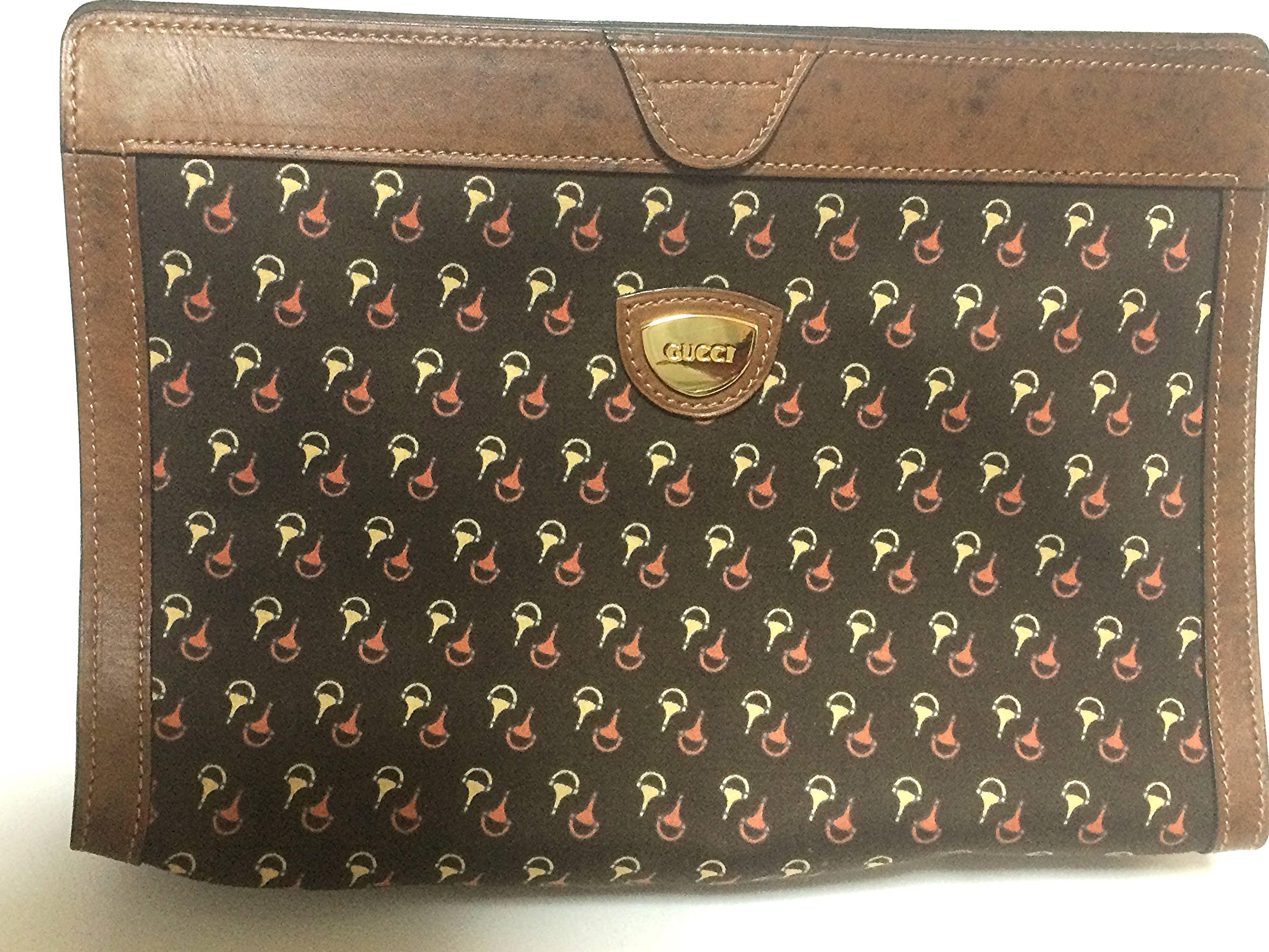 1980s. Vintage Gucci brown toiletry clutch pouch with all over horsebit print canvas with leather trimming.

Introducing one of the rarest vintage Gucci items from 80s.
Clutch cosmetic/toiletry use purse with print canvas and leather