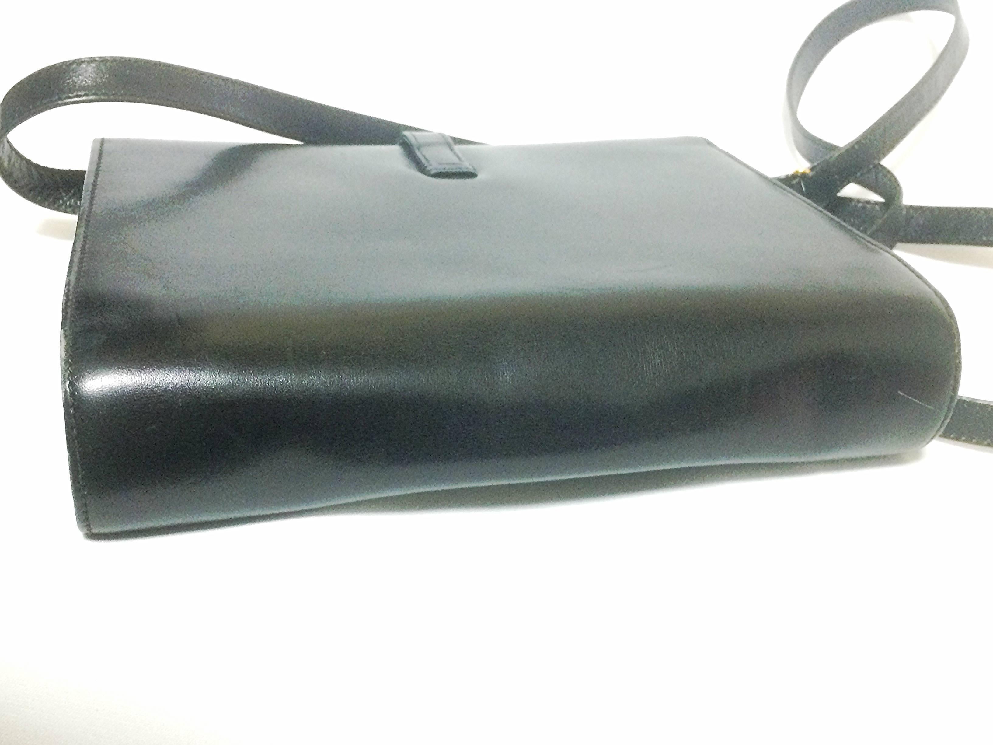 Black 80’s Vintage Gucci black leather clutch shoulder bag with logo motif closure.