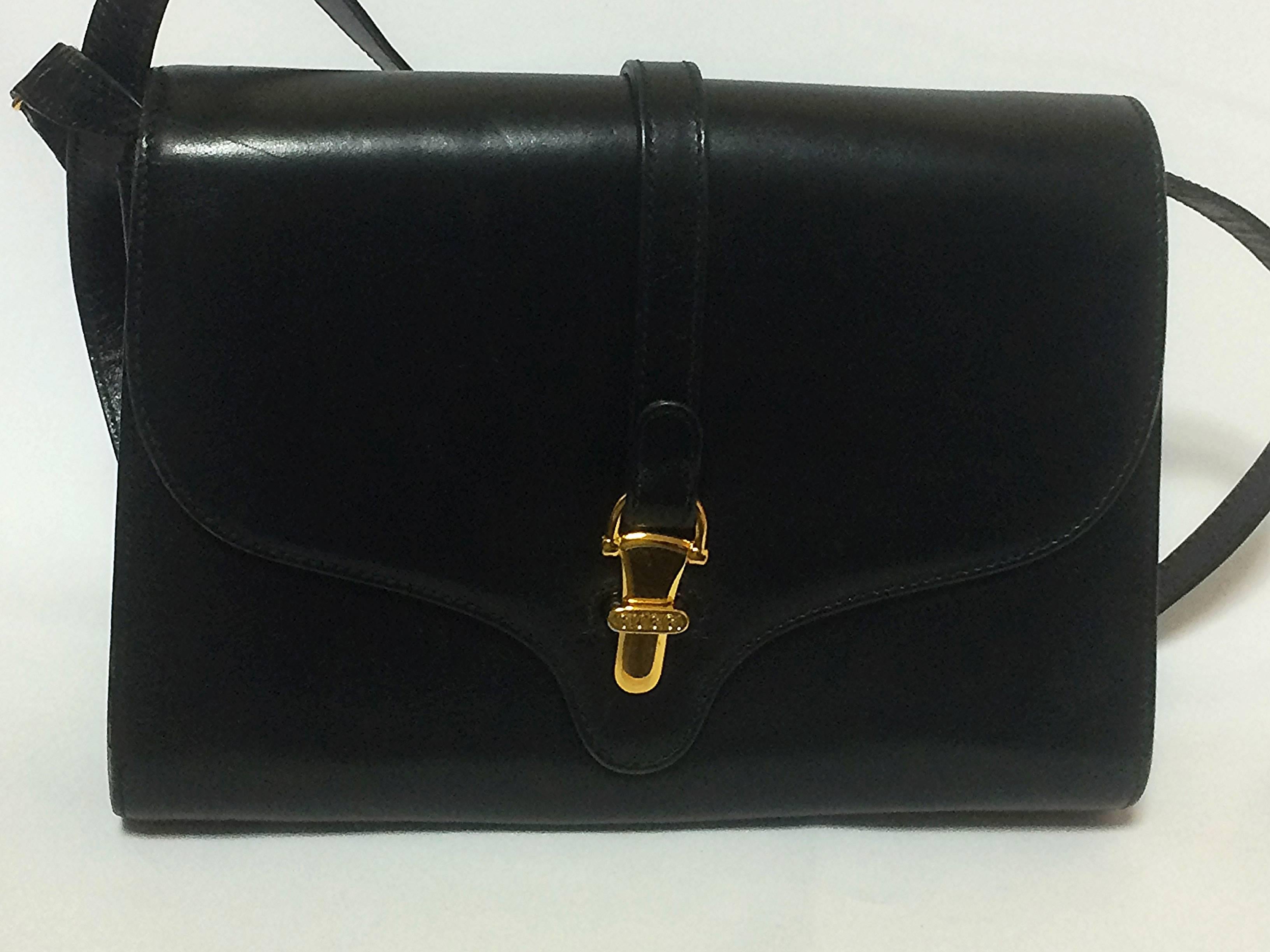1980s. Vintage Gucci black leather clutch shoulder bag with logo motif closure. Classic and elegant daily use vintage Gucci bag

Introducing a masterpiece, leather shoulder from Gucci back in the 80's.
Very sophisticated purse that would never go