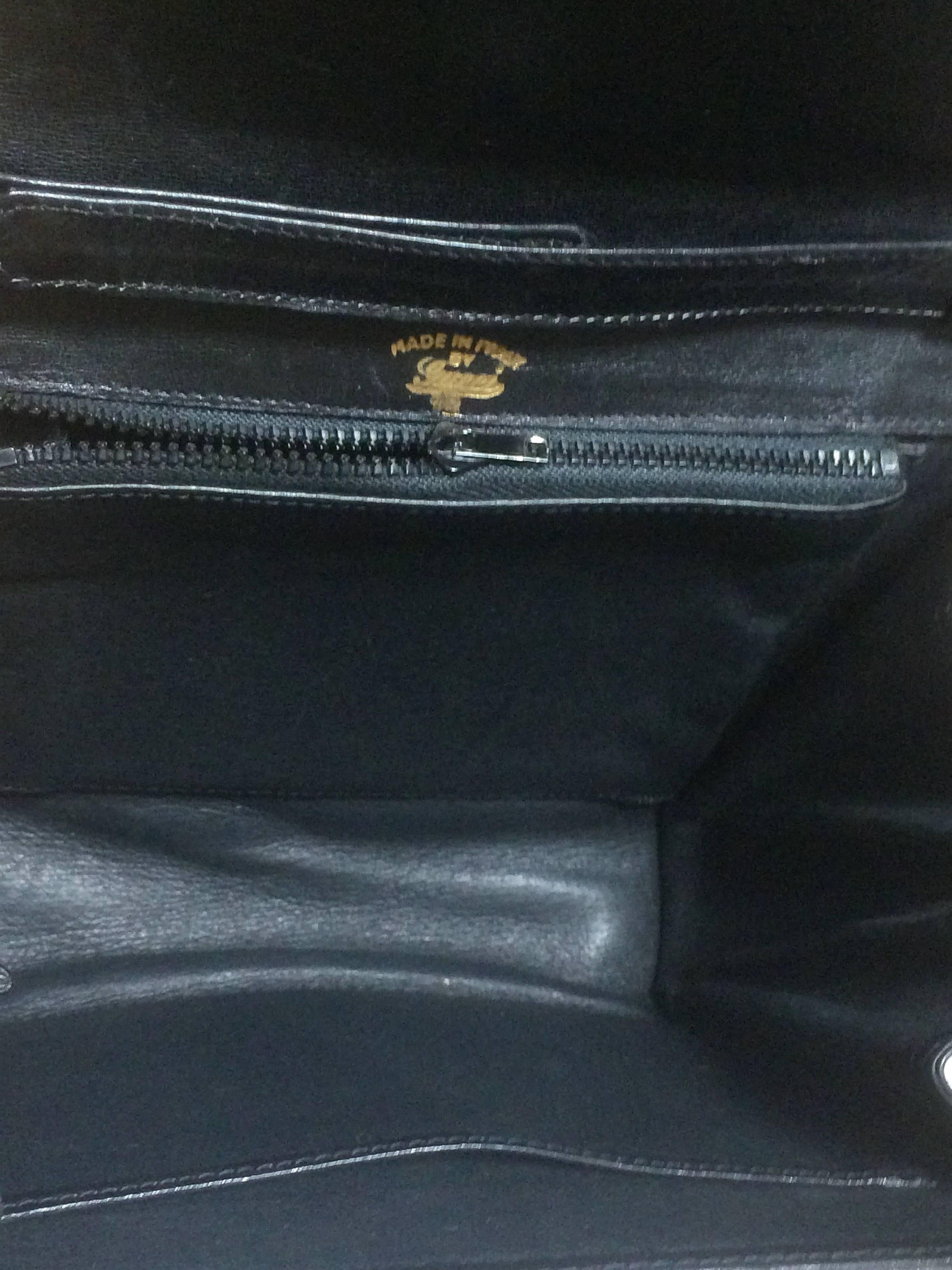 Women's 80’s Vintage Gucci black leather clutch shoulder bag with logo motif closure.