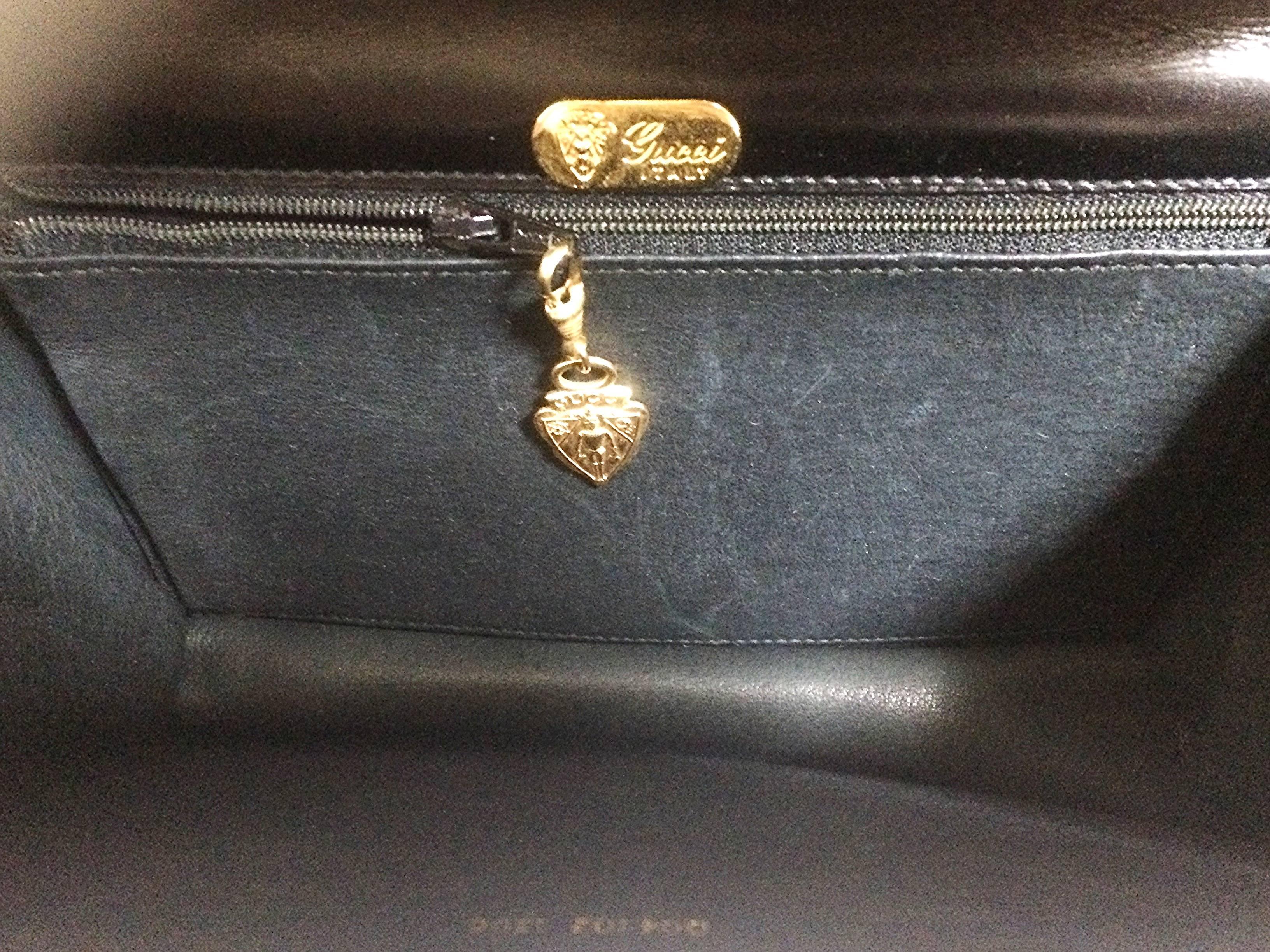 Vintage Gucci black leather shoulder bag with golden logo embossed oval mot 2