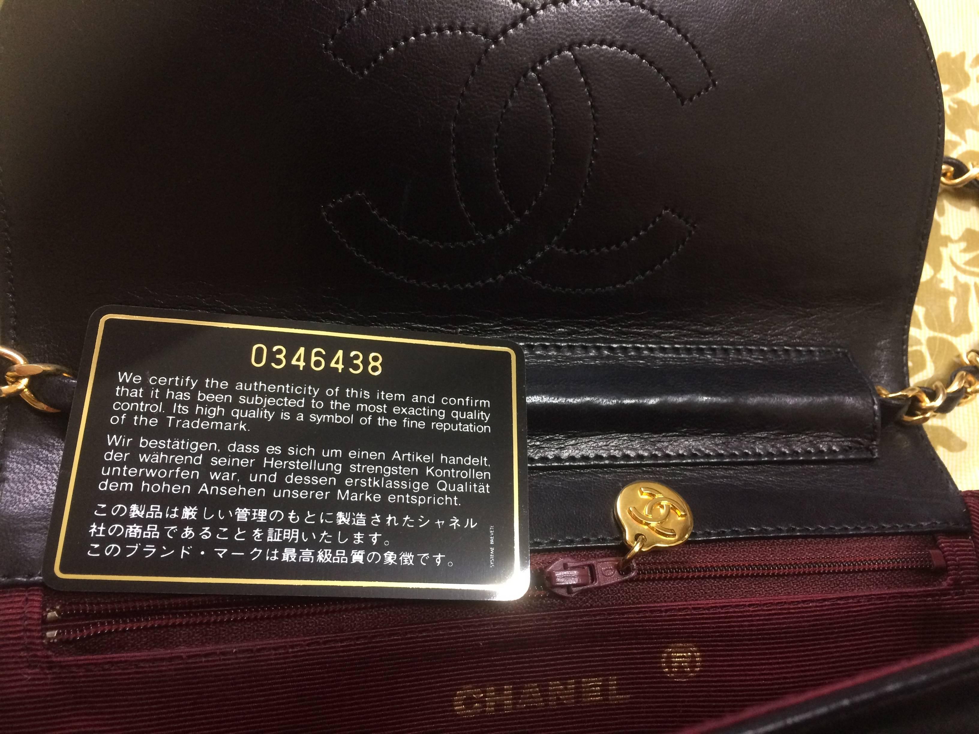 Black Vintage Chanel black lambskin half moon 2.55 chain shoulder bag with golden CC.