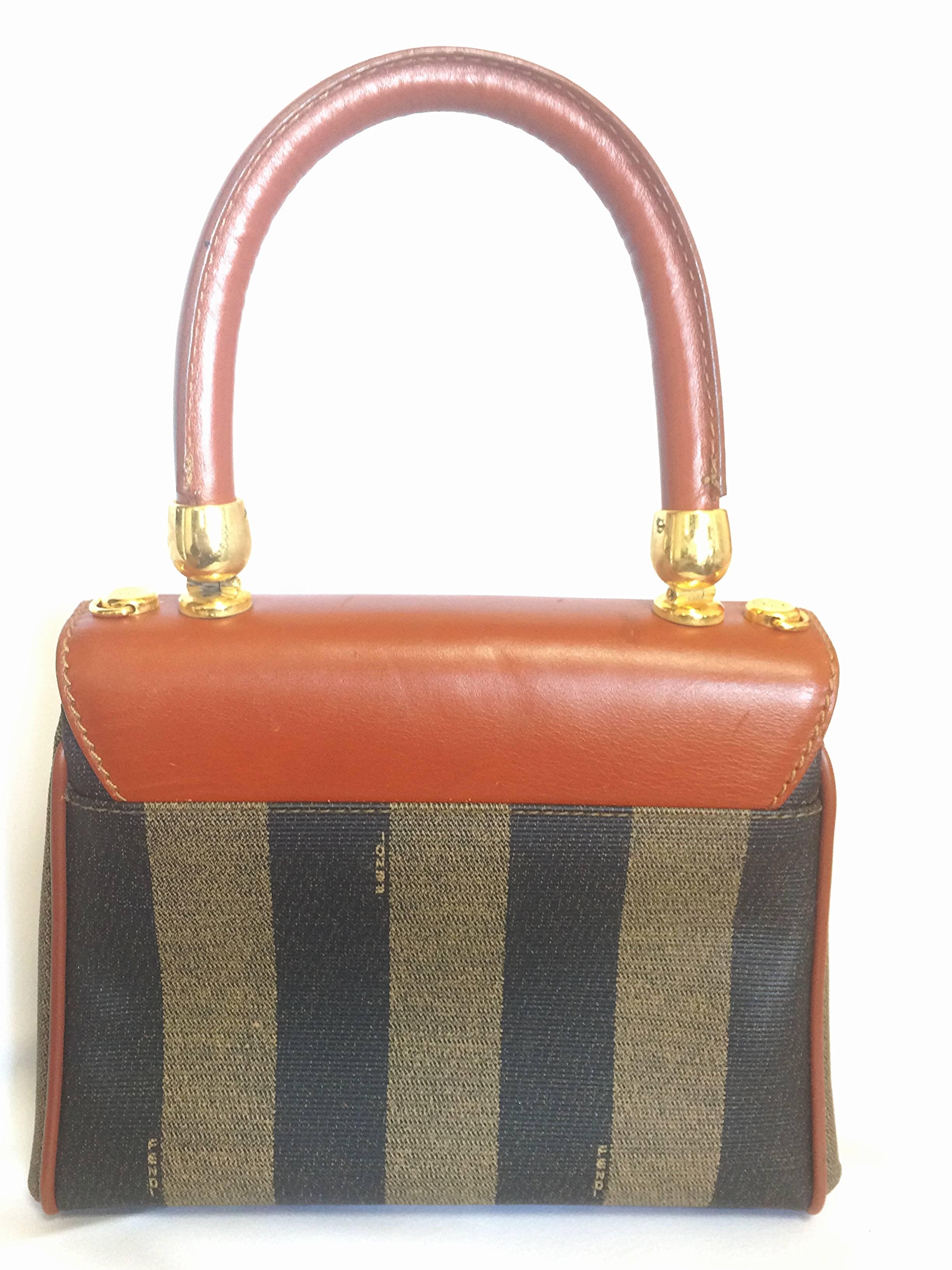 1990s. Vintage FENDI kelly bag style mini handbag in classic pecan stripes and brown leather handle. Classic vintage bag

For all FENDI vintage lovers, this classic purse is here for you!
Introducing a classic kelly style mini bag with pecan