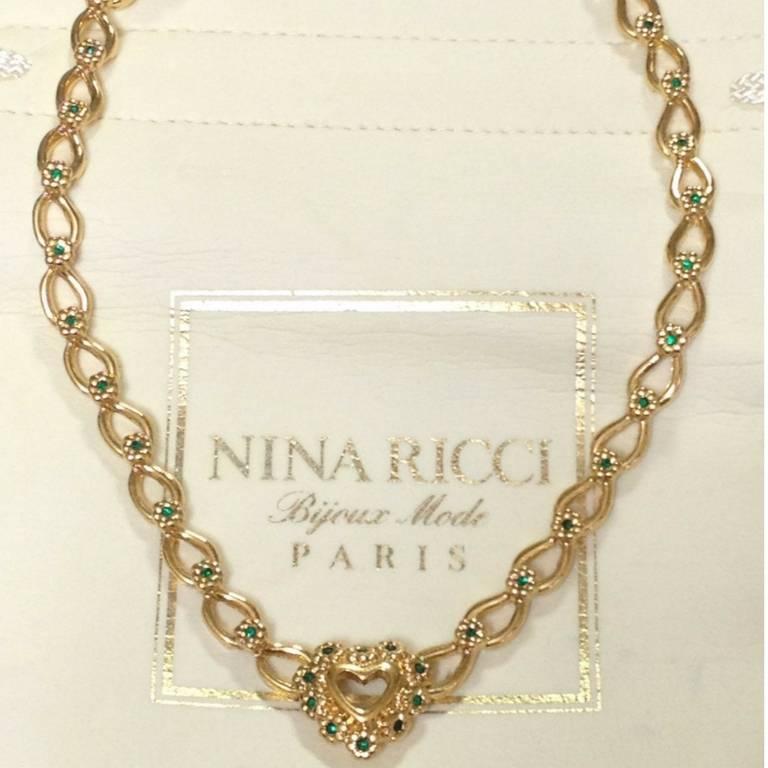 1990s. MINT. Vintage NINA RICCI statement necklace with heart shape and flower motifs with green crystal stones. Rare and gorgeous gift.

Introducing a vintage masterpiece, vintage jewelry, a statement necklace from Nina Ricci back in the