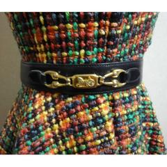 Vintage Celine black leather belt with golden carriage and horse motif. 65