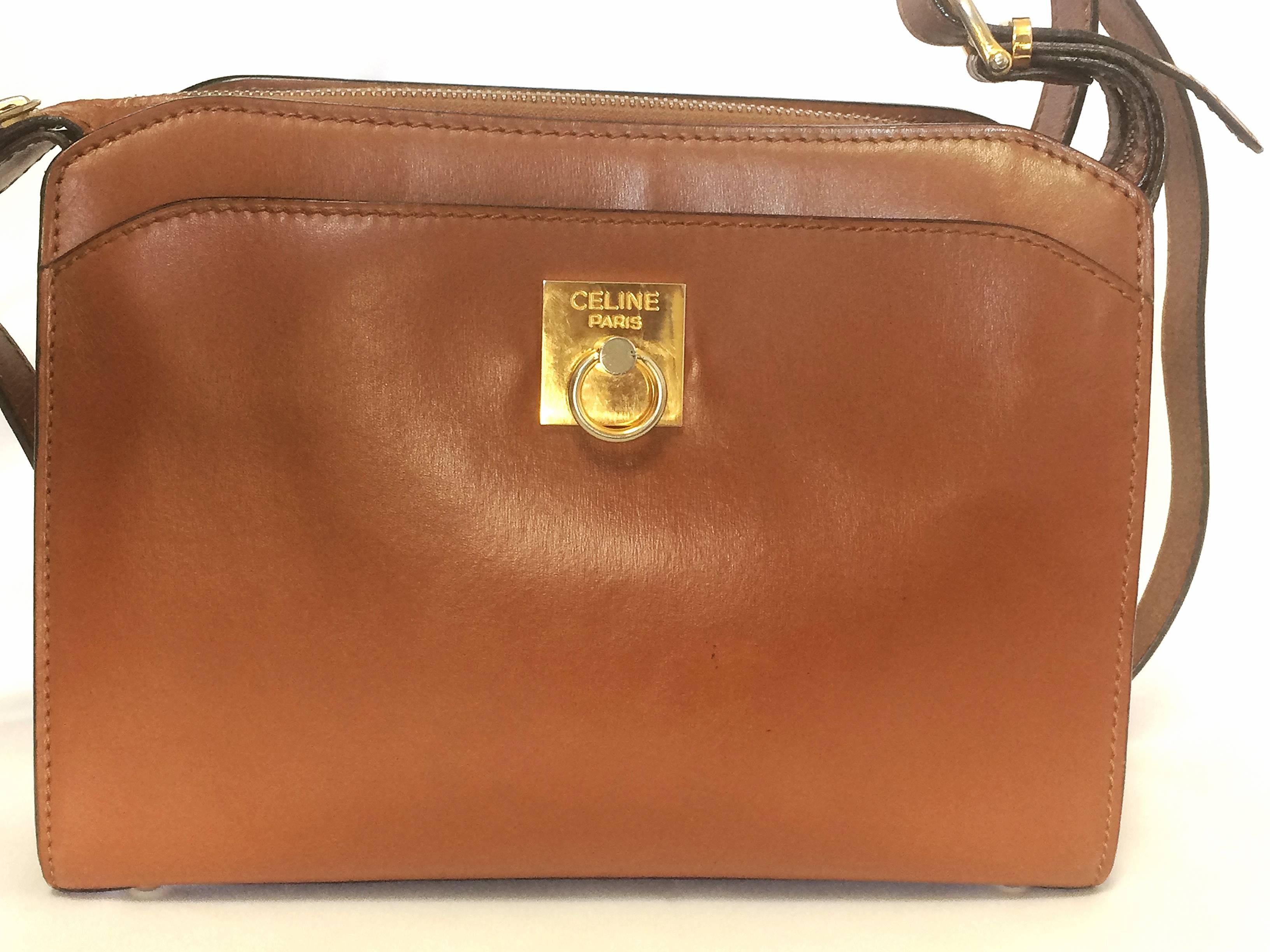 1990s. Vintage CELINE genuine brown leather shoulder bag with golden logo motif at front. Rare Celine leather bag

For all CELINE vintage lovers, this unique and rare vintage masterpiece is right for you!
Classic purse in brown