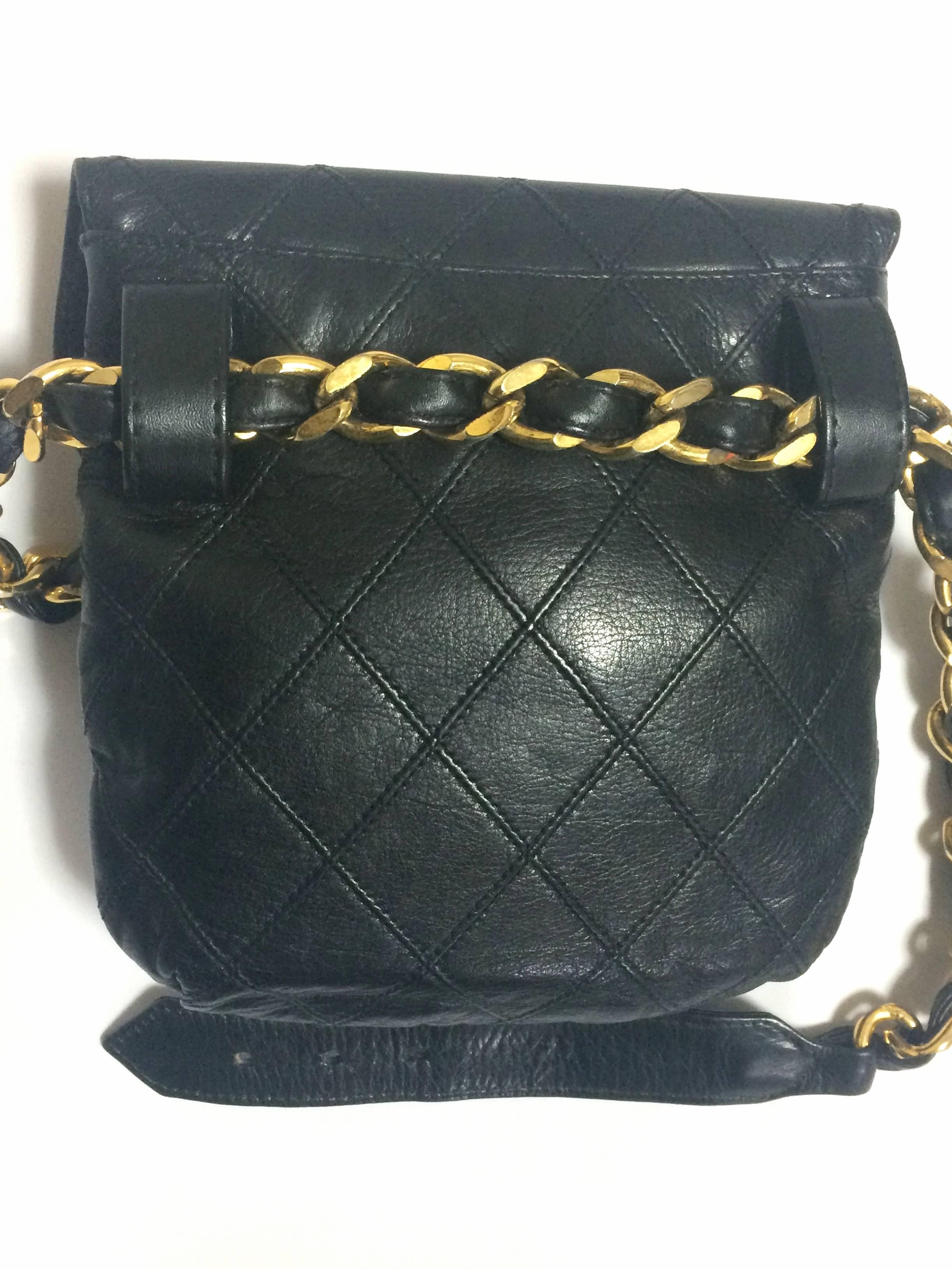 1990s. Vintage CHANEL black leather waist purse, fanny pack with golden thick chain belt and golden CC closure hock. 26", 26.5",27", and 27.5".

Featuring a gold tone CC turn lock closure, though it shows some colorfading. 
You