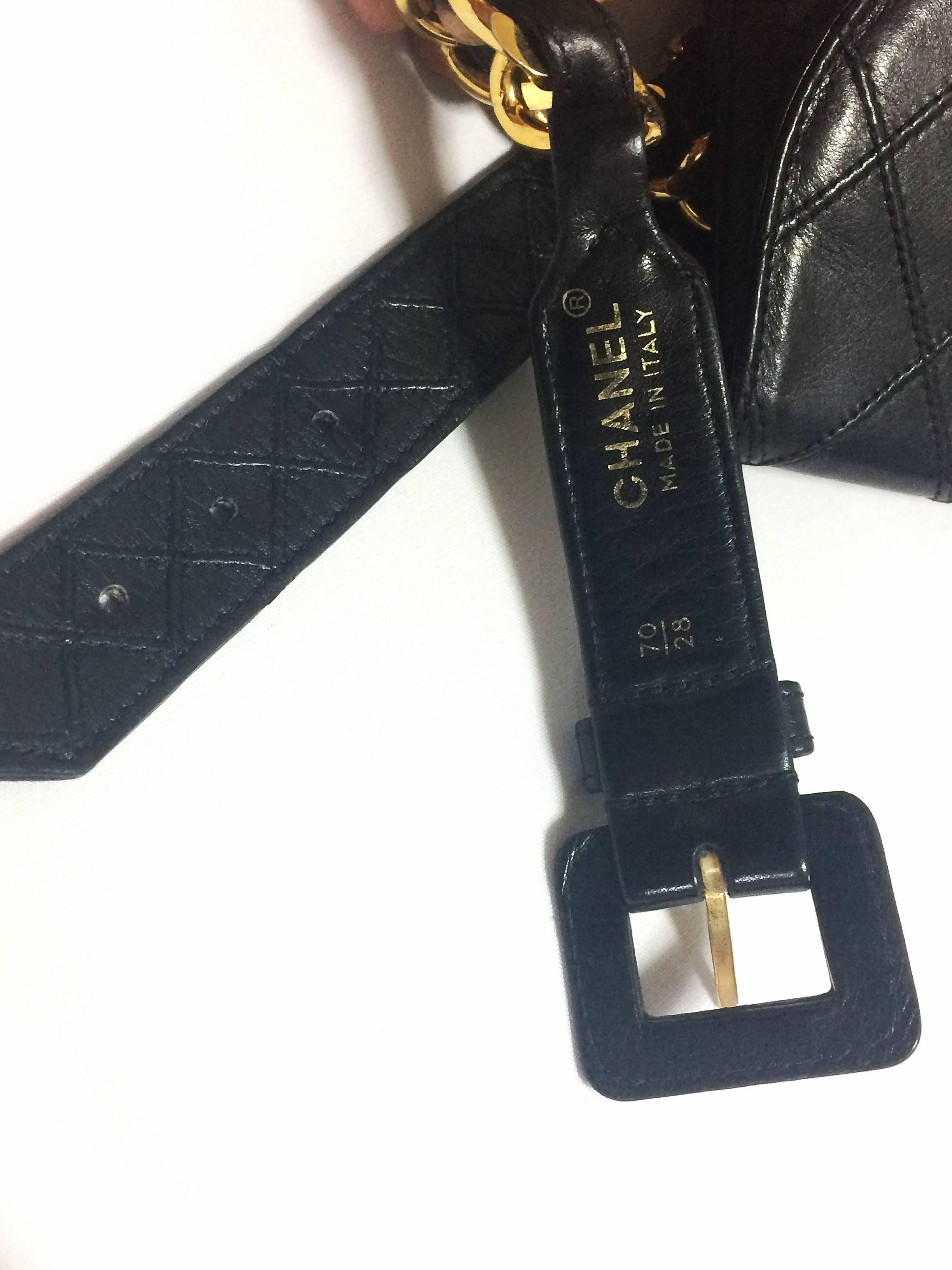 Women's Vintage CHANEL black leather waist purse, fanny pack with golden chain belt.