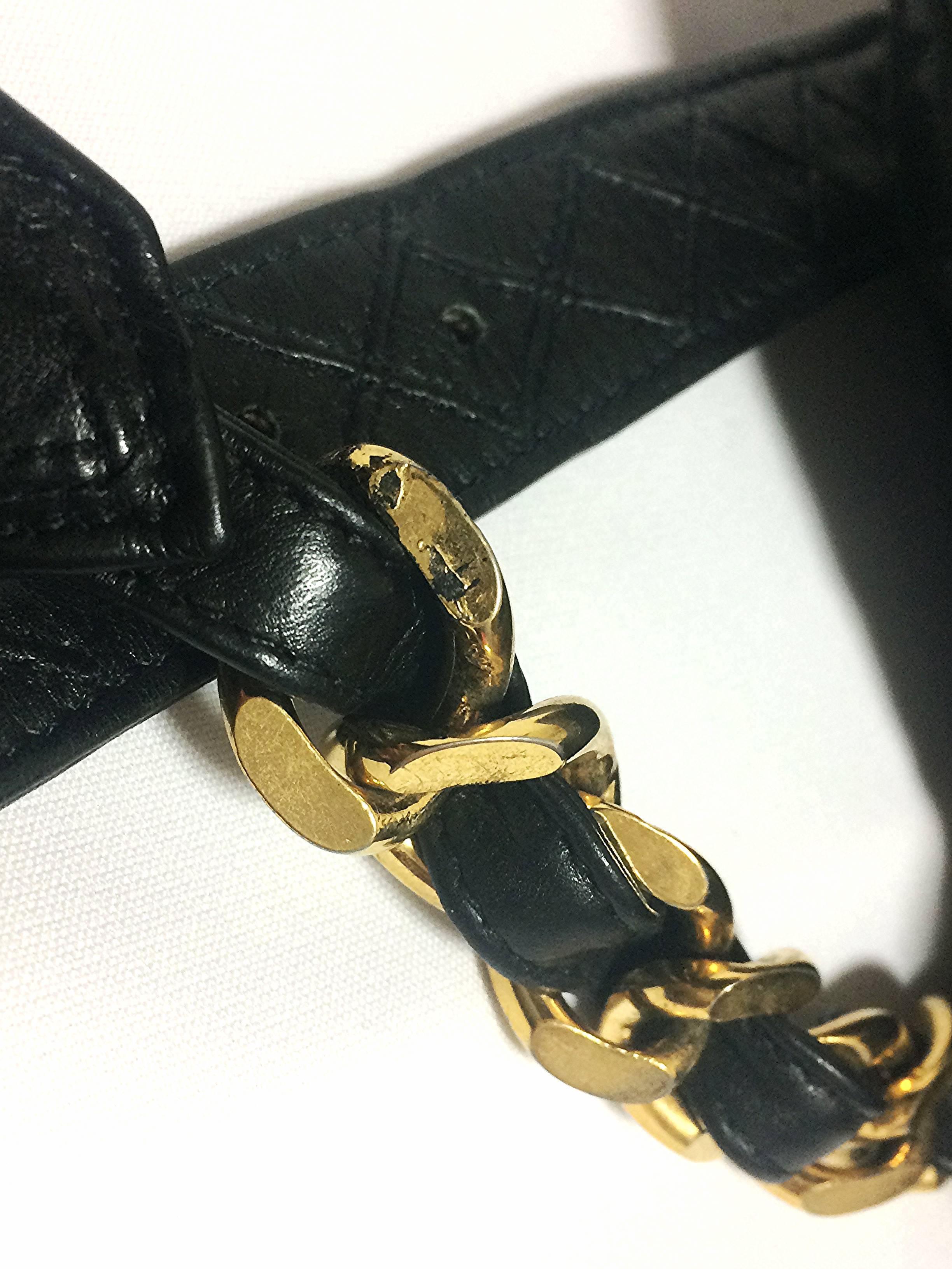 Black Vintage CHANEL black leather waist purse, fanny pack with golden chain belt.