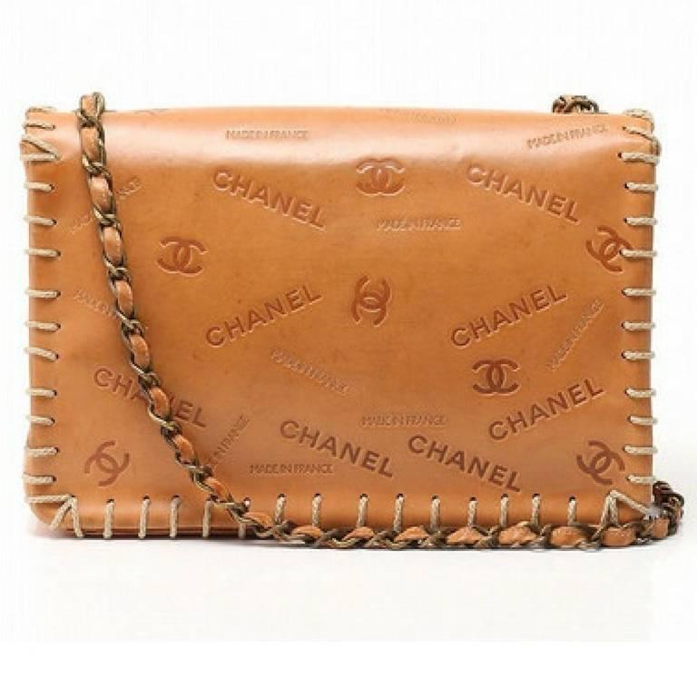 Vintage CHANEL tan brown allover logo embossed leather jumbo, large 2.55 shoulder bag with large stitches and bronze color chains. Rare bag.

Introducing one of the rarest vintage pieces from CHANEL, a large/jumbo size tanned brown leather