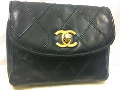 Vintage CHANEL black leather waist bag, fanny pack with golden chain belt.