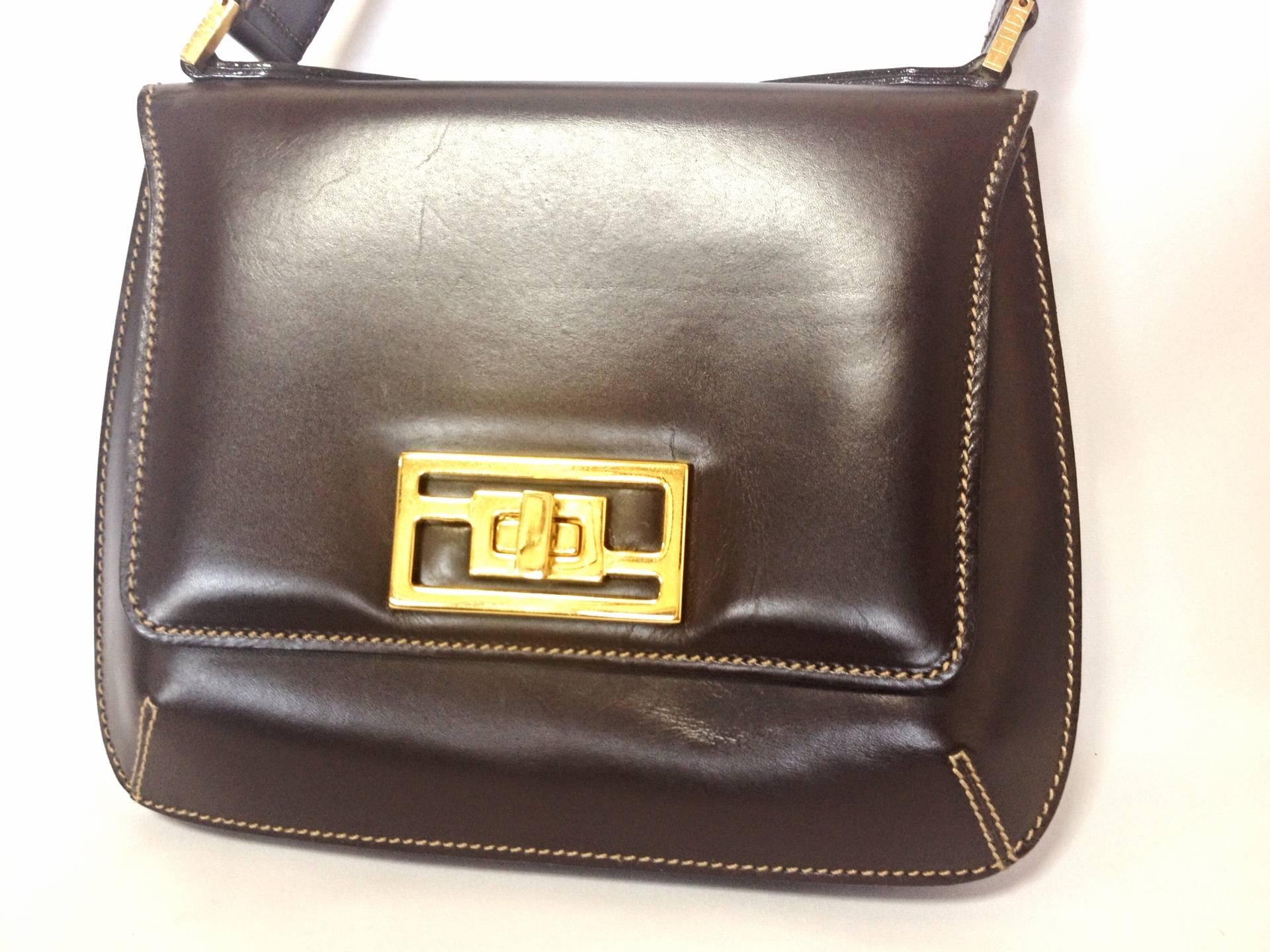 1990s. Vintage FENDI genuine dark brown leather handbag with golden FF logo at closure. Rare masterpiece

Introducing another masterpiece leather bag from FENDI back in the 90's.
This classic handbag would never go out of style. Very classic and yet