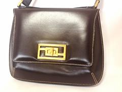Vintage FENDI genuine dark brown leather handbag with golden FF logo at closure.