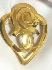 Vintage CHANEL gold tone heart and snail design brooch with CC mark at center.