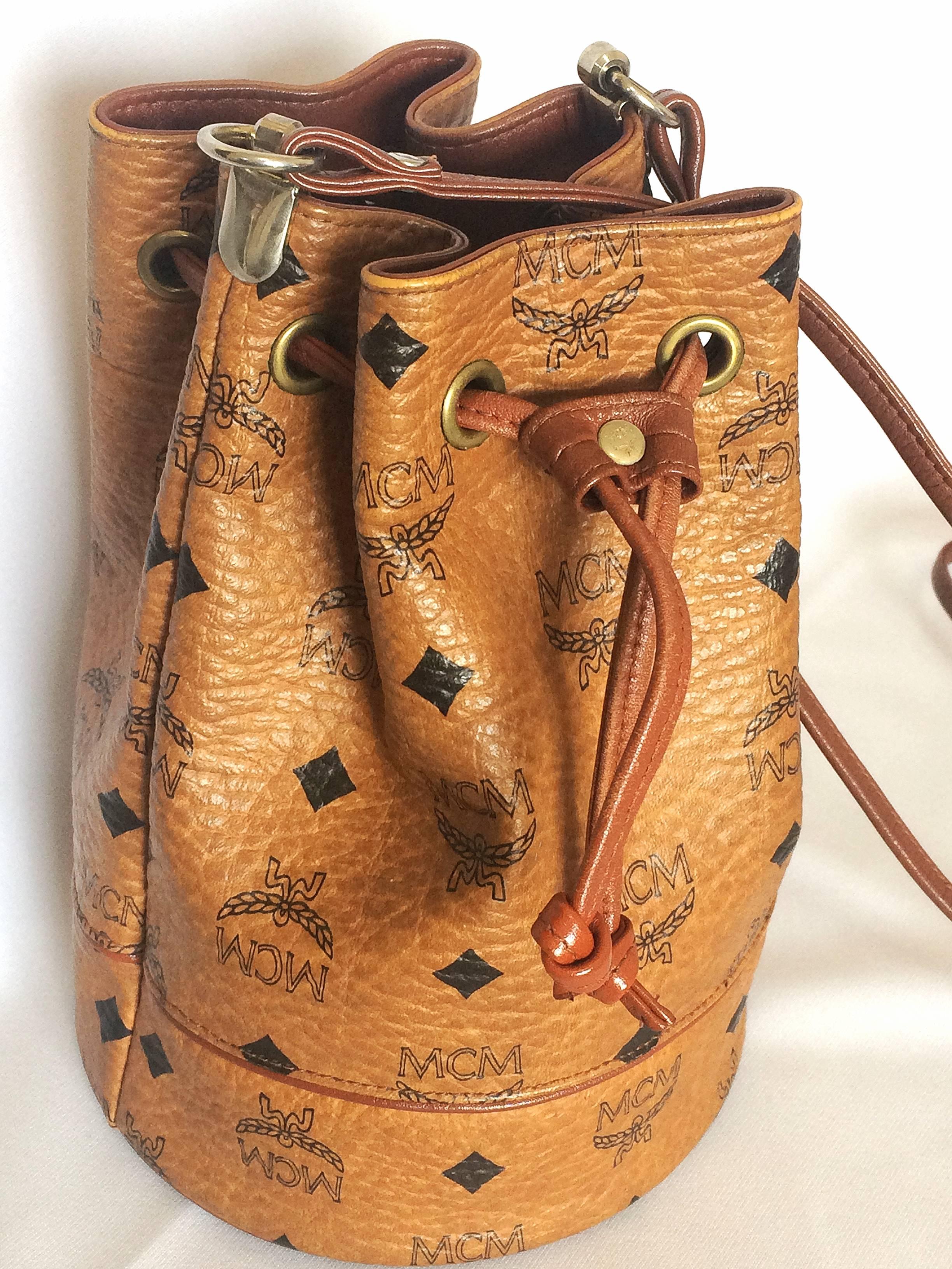 1990s. Vintage MCM brown monogram small hobo bucket bag. mini purse. So chic and cute. Designed by Michael Cromer.

MCM has been back in the fashion trend again!!
Now it's considered to be one of the must-have designer in fashion.

Introducing