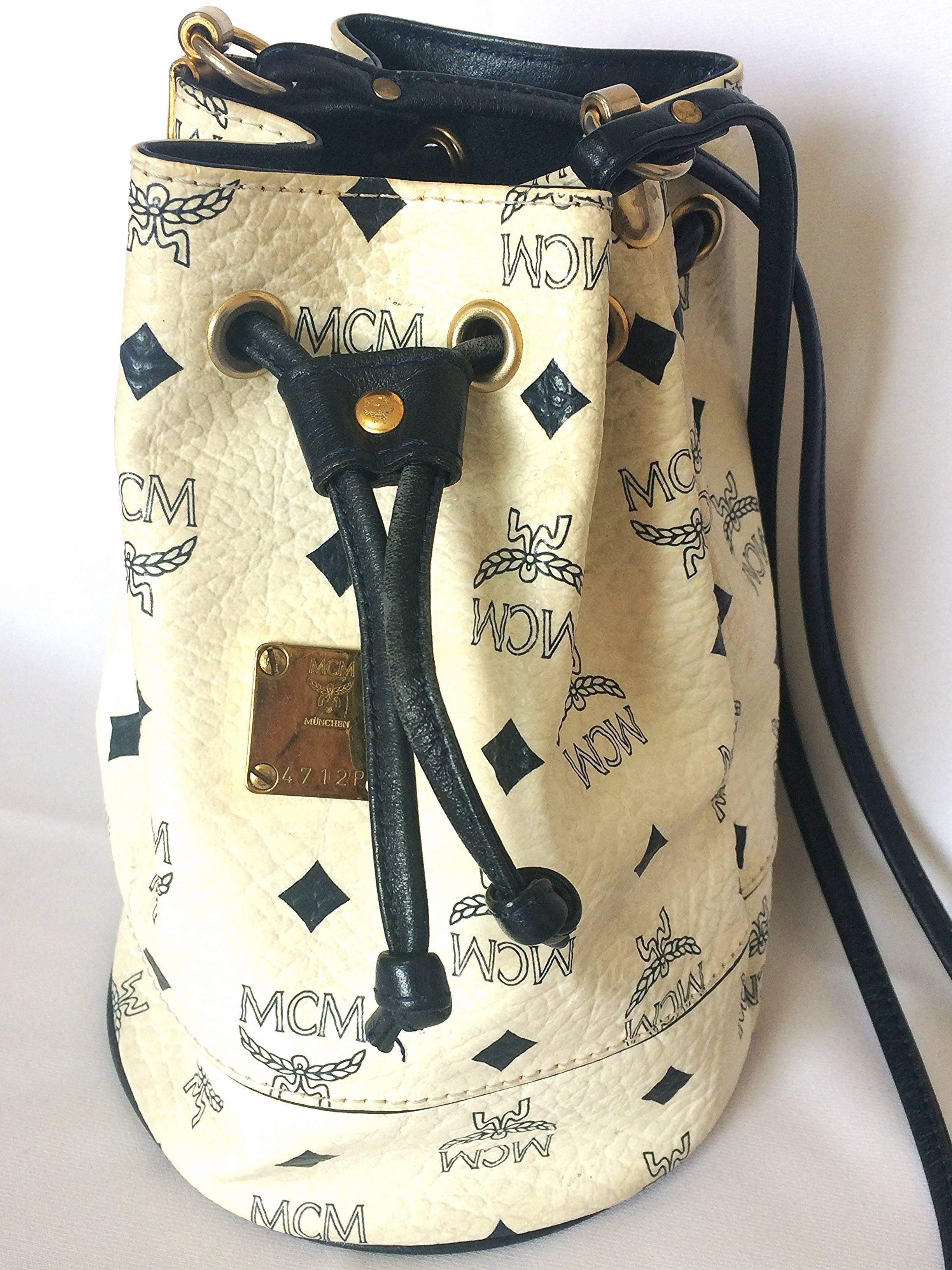 1990s. Vintage MCM white/ivory and navy monogram small hobo bucket bag. So chic and cute. Great vintage gift.

MCM has been back in the fashion trend again!!
Now it's considered to be one of the must-have designer in fashion.

Introducing a