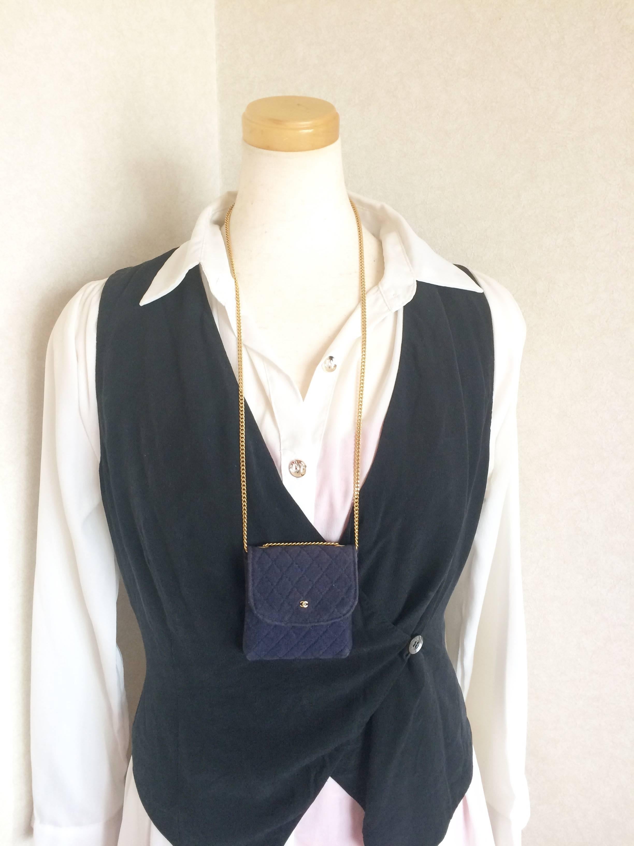 1990s. Vintage Chanel navy quilted jersey fabric mini pouch, coin purse, long necklace with golden chain and CC motif. Great gift Chanel jewelry

Introducing one of the most popular item from Chanel back in the era, necklace type mini pouch that