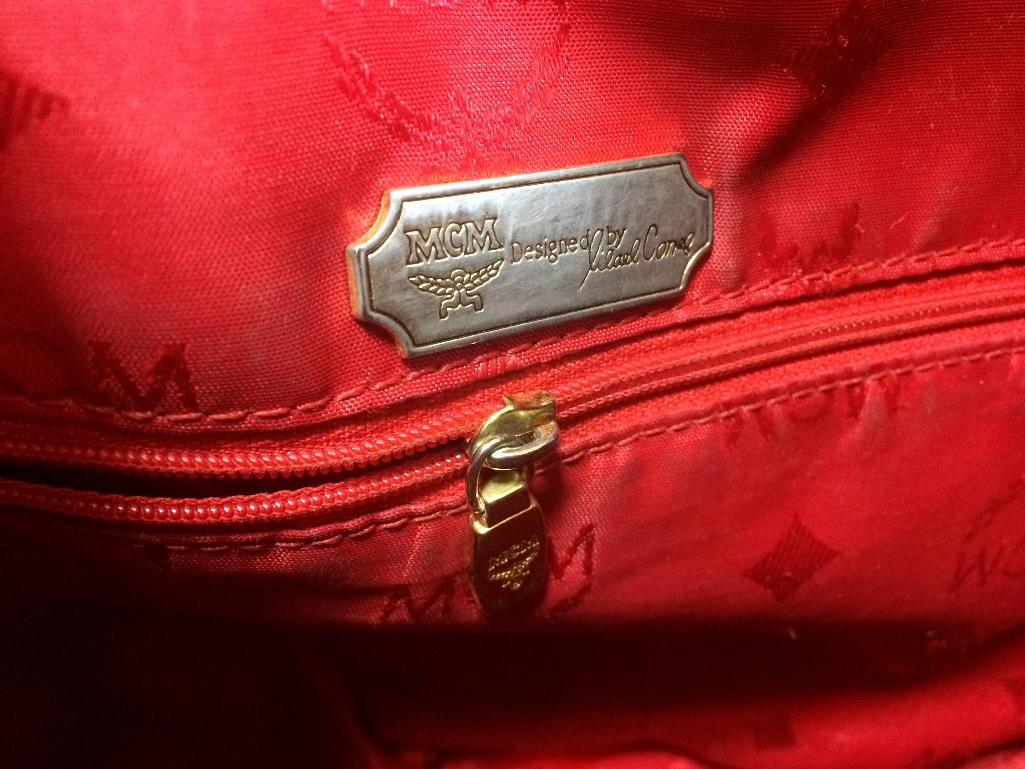 Vintage MCM genuine leather red hobo bucket shoulder bag with gold tone motifs. For Sale 1