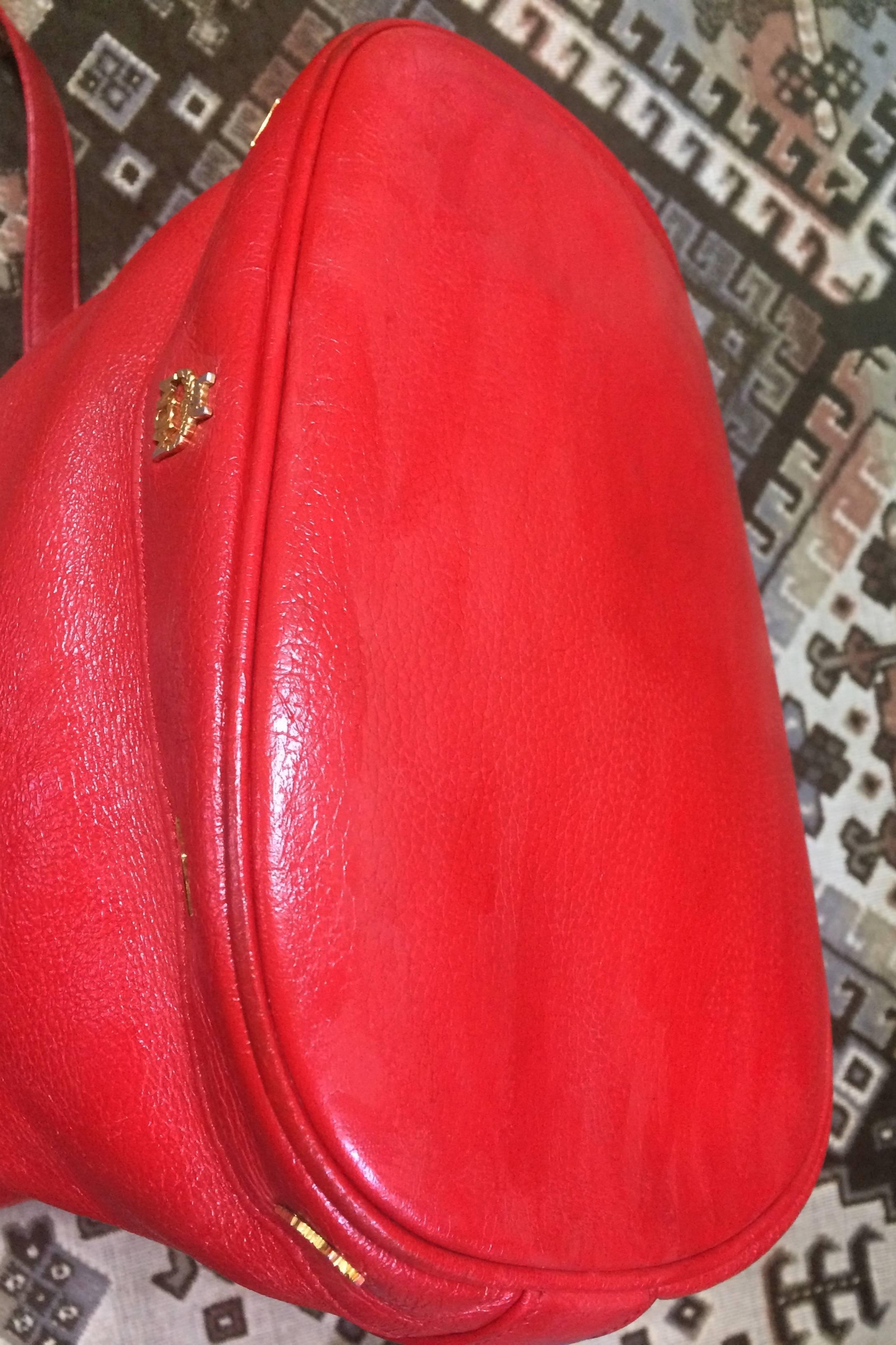 Orange Vintage MCM genuine leather red hobo bucket shoulder bag with gold tone motifs. For Sale