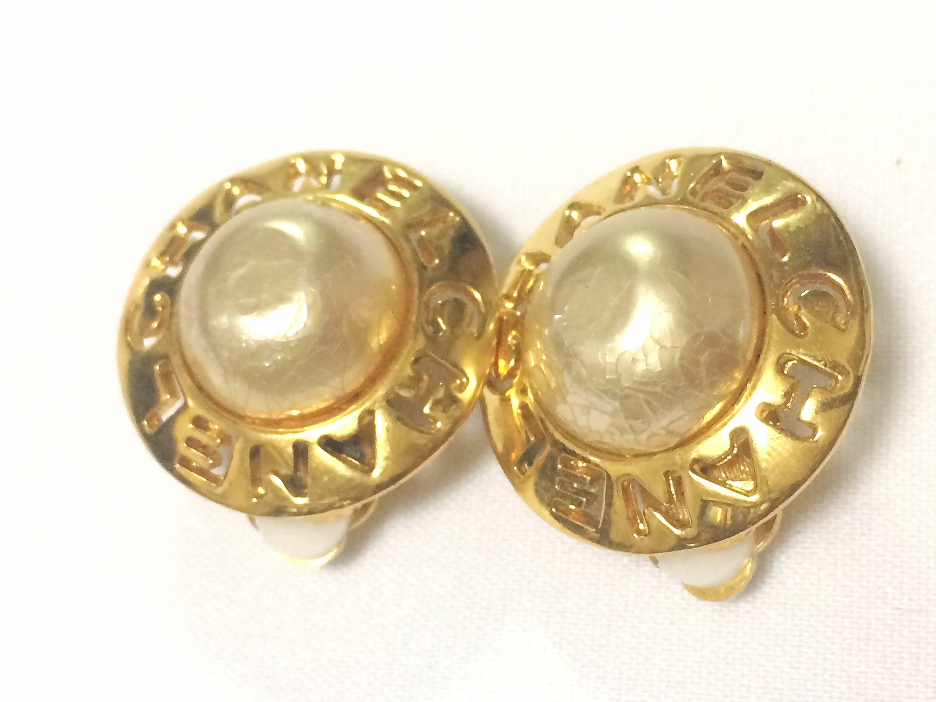 1990s. Vintage CHANEL golden round shape faux pearl earrings with cutout logo. Chic and elegant look.

Fun and Chic and Gorgeous CHANEL earrings for  you or your loved one!  
Classic round shape faux pearl and golden earrings. 
Featuring cutout