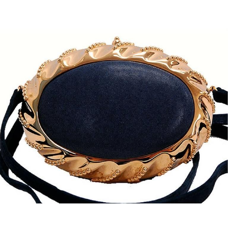 1990s. Vintage Hermes rare oval shape black leather and golden brass frame clutch bag. Perfect purse for party. 

Beautiful masterpiece, oval design black clutch party bag from Hermes back in the 90's. 
One-of-a-kind purse for your