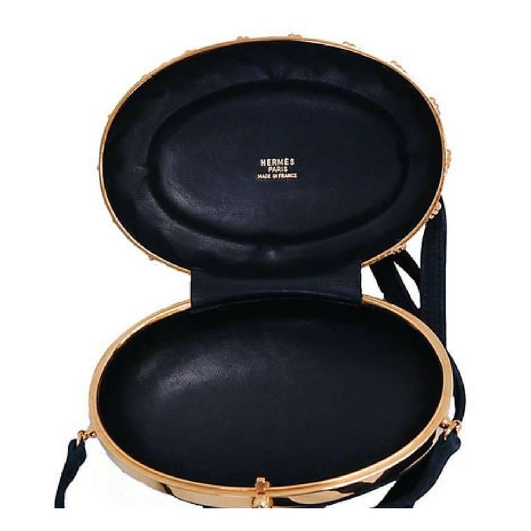 Vintage Hermes rare oval shape black leather and golden brass frame clutch bag. For Sale 1