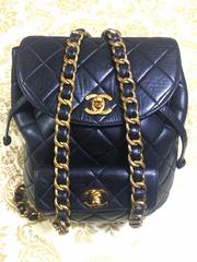 Vintage CHANEL quilted black lamb leather backpack with gold chain and CC.