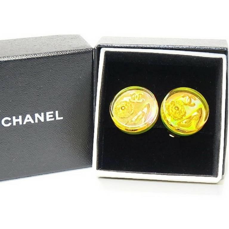 1990s. Vintage CHANEL orange aurora earrings with Chanel iconic charms. Shoe, camellia, and CC mark in it. Perfect.

You are seeing one of the most gorgeous vintage earrings from CHANEL.
The plastic round plate holds Chanel's iconic charms, shoe,
