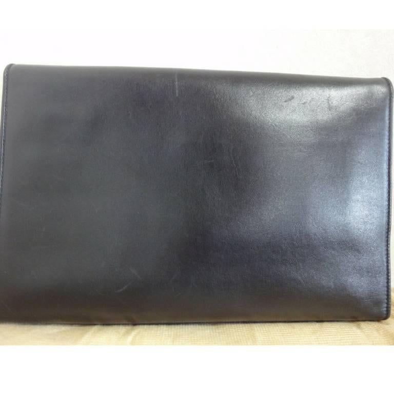 Black Vintage Celine black calfskin leather clutch bag with iconic golden logo motif. For Sale