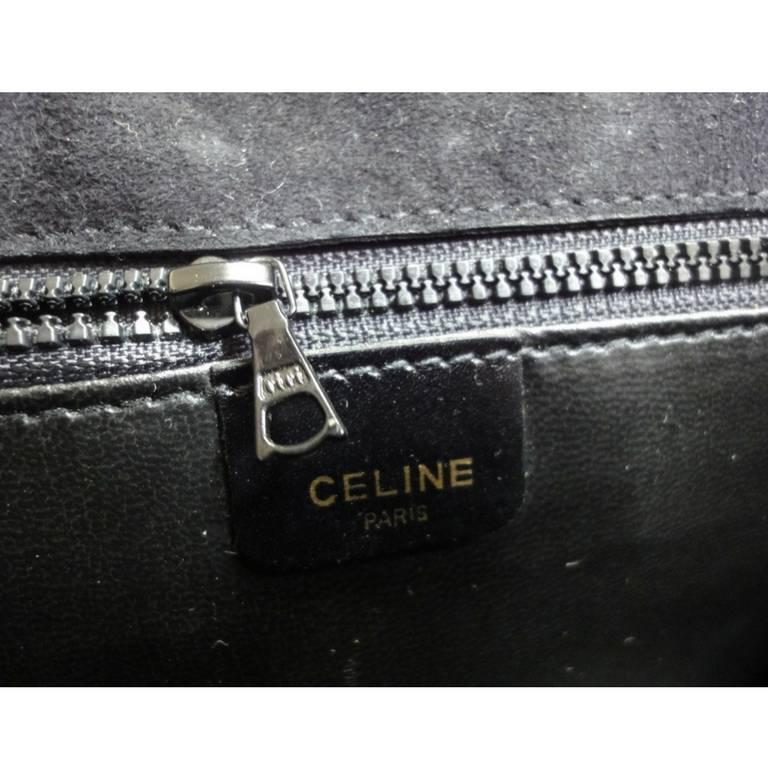 Women's or Men's Vintage Celine black calfskin leather clutch bag with iconic golden logo motif. For Sale