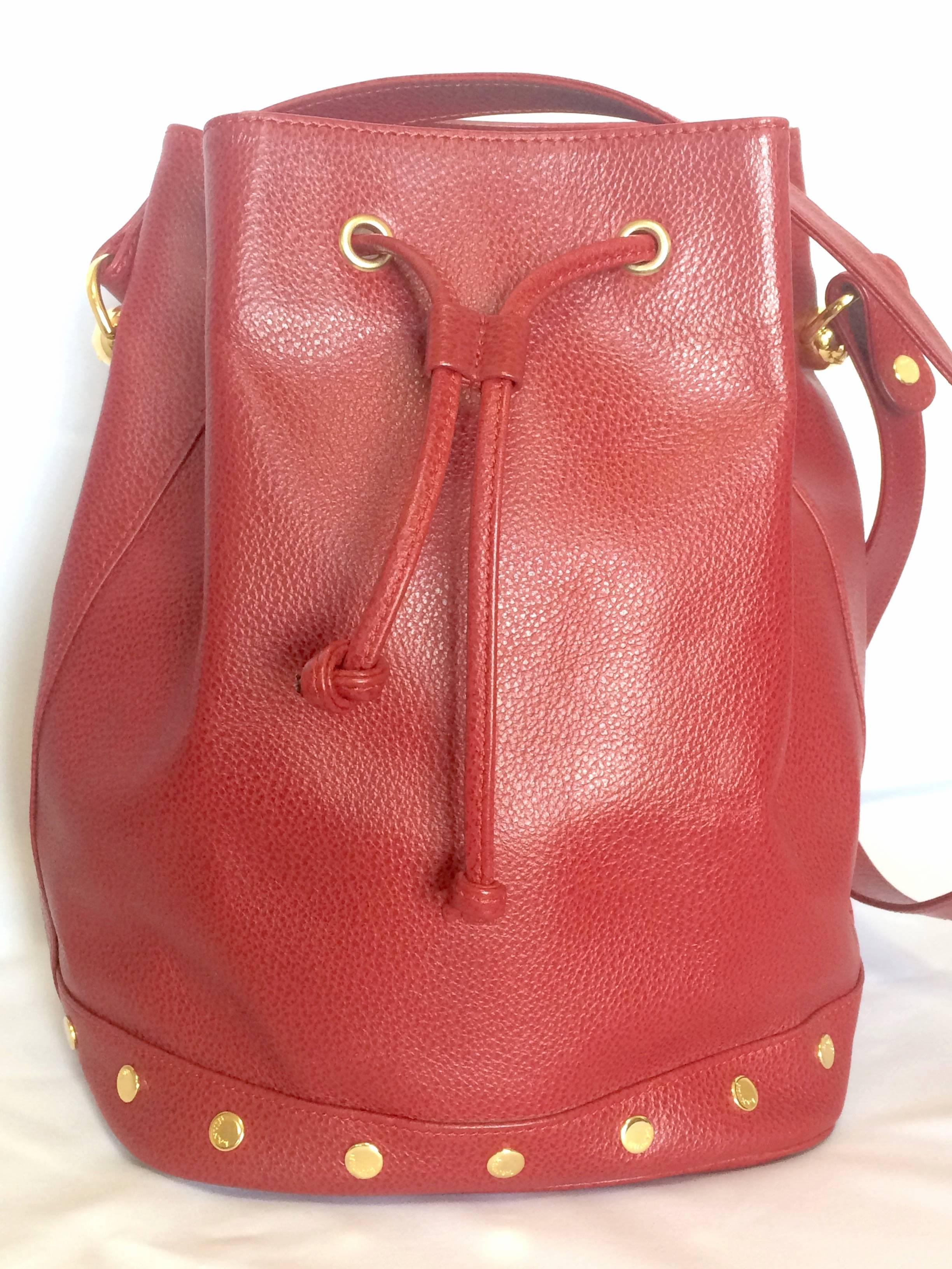 1990s. Vintage LANVIN apricot red hobo bucket shoulder bag with studded logo motifs.

Introducing another beautiful masterpiece shoulder bag from LANVIN back in the 90's.
You will love the beautiful apricot red color grained leather with golden logo