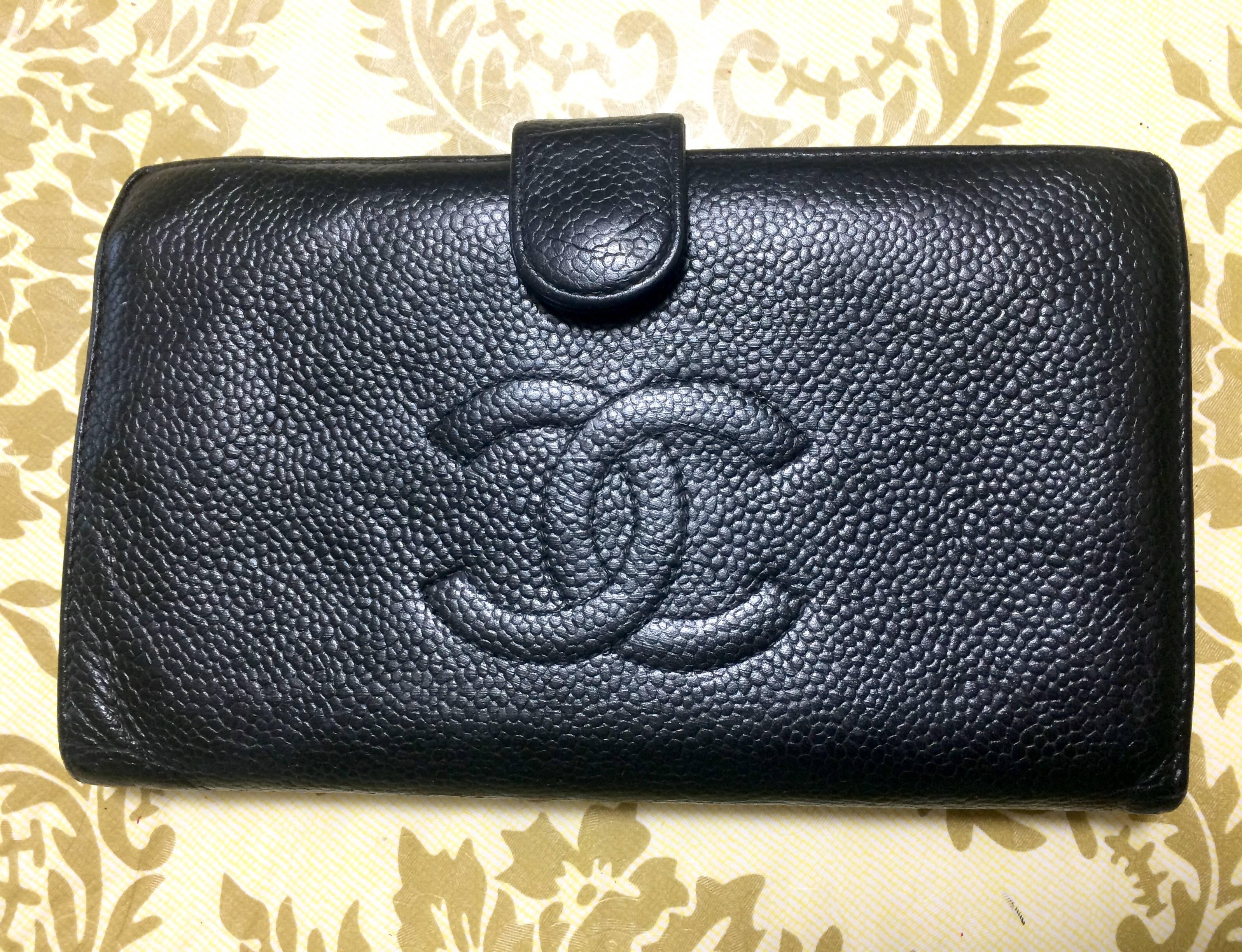 Vintage CHANEL black caviar leather wallet with large CC stitch mark logo. Classic wallet.

This is a CHANEL vintage wallet in classic black caviar leather. 
Modest, simple and elegant.
It is something that would never go out of style.
The CC