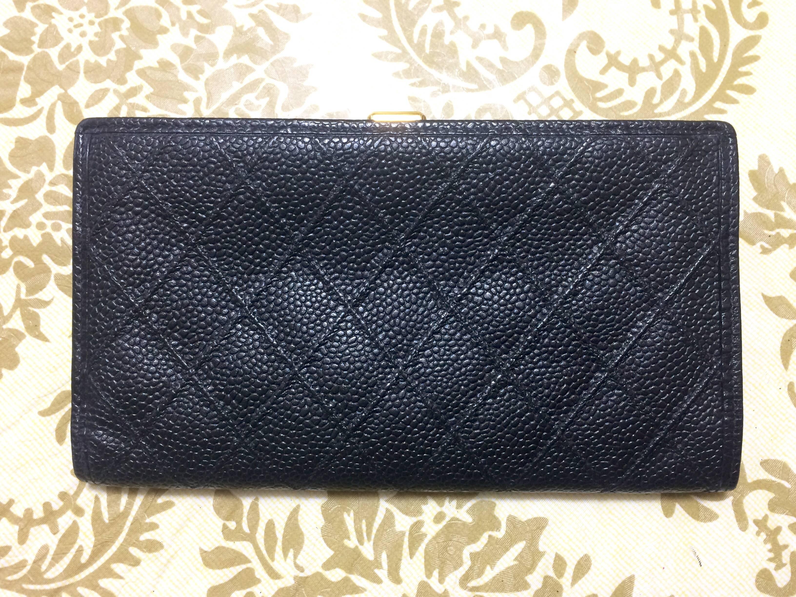1990s. Vintage CHANEL black caviar leather wallet with stitches and gold tone CC motif. Perfect gift.

This is a CHANEL vintage wallet in black caviar leather from the 90's. 
Very sophisticated looking and something that would never go out of