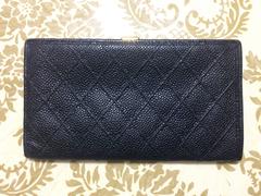 Vintage CHANEL black caviar leather wallet with stitches and gold tone CC motif.