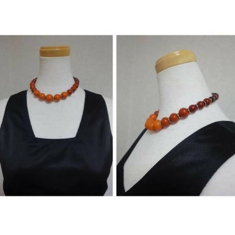 1980s. Vintage Yves Saint Laurent orange brown gradation color ball statement necklace.

This is a rare statement necklace from Yves Saint Laurent approx from 80s.
Consisting of various size balls in orange and brown and those gradation colors with