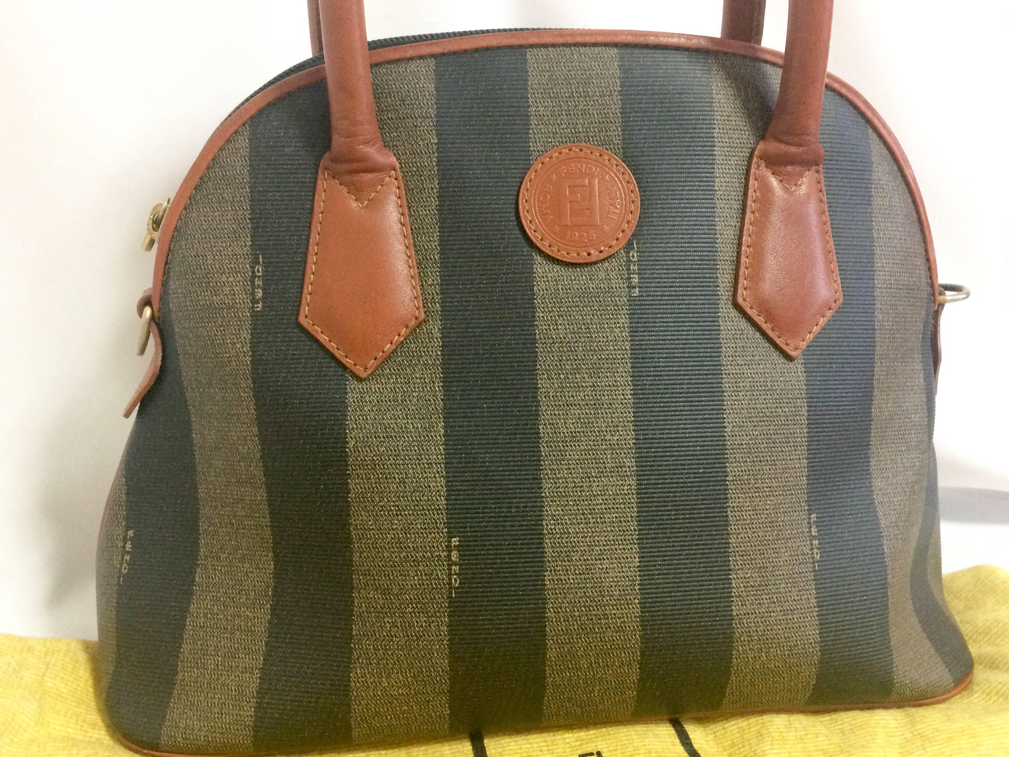 1990s. Vintage FENDI pecan khaki and gray stripe bag with brown leather handles and trimmings in bolide shape.

This is a FENDI conic pecan pattern purse in bolide shape from the early 90's. 
Very classic and yet elegant.
Perfect daily use bag for