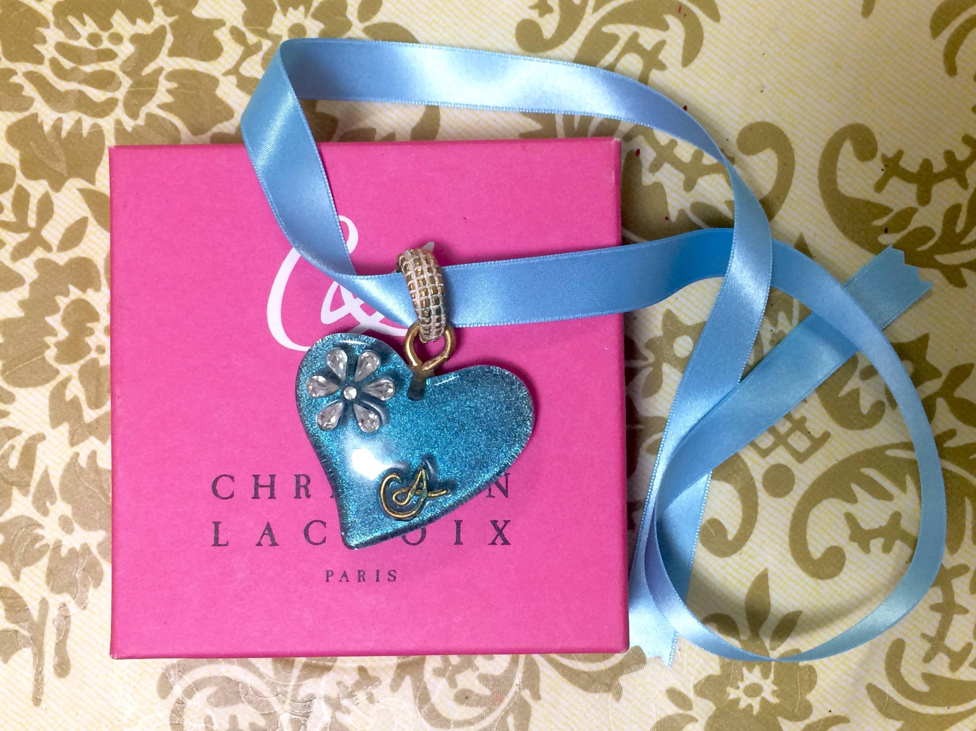 1990s. Vintage Christian Lacroix blue ribbon choker necklace with large blue lame heart pendant top.

Introducing another fabulous and unique vintage jewelry piece from Christian Lacroix from 90's. 

Featuring a plastic large heart lame pendant top