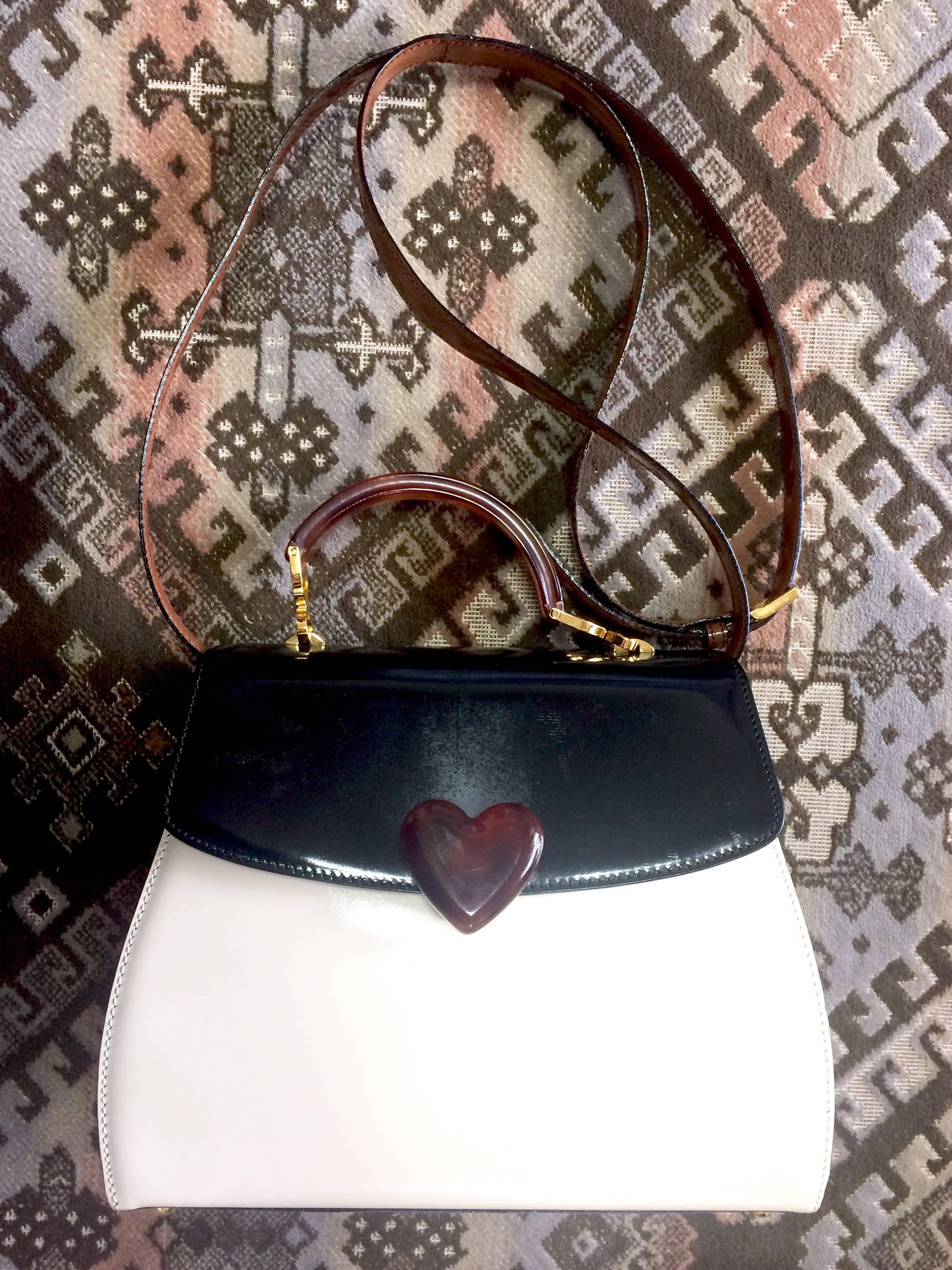 1990s. Vintage MOSCHINO white, black, brown patent enamel handbag, shoulder bag with heart motif. Adorable purse by Red Wall.

Introducing a beautiful tricolor enamel leather bag, shoulder bag from Moschino back in the 90's, produced by Red Wall.