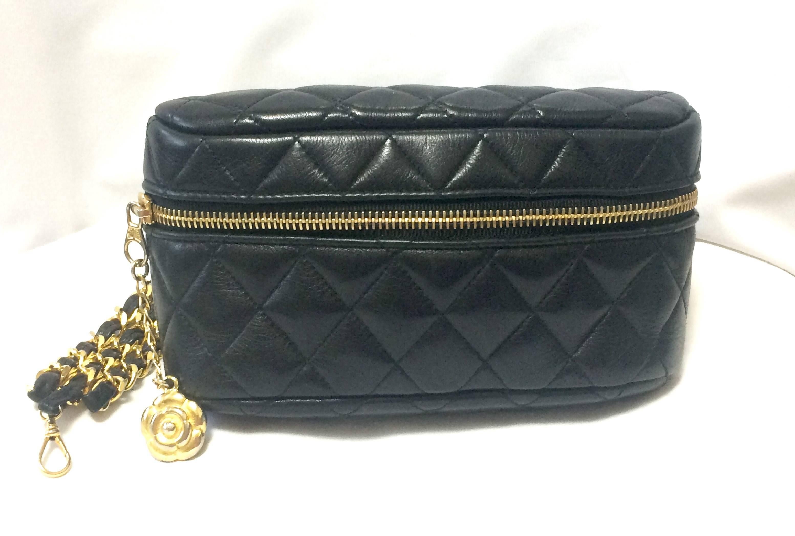 1990s. Vintage CHANEL black leather waist bag, fanny pack with triple chain leather belt and a dangling camelia flower charm. Rare and unique purse for waist size  up to 26