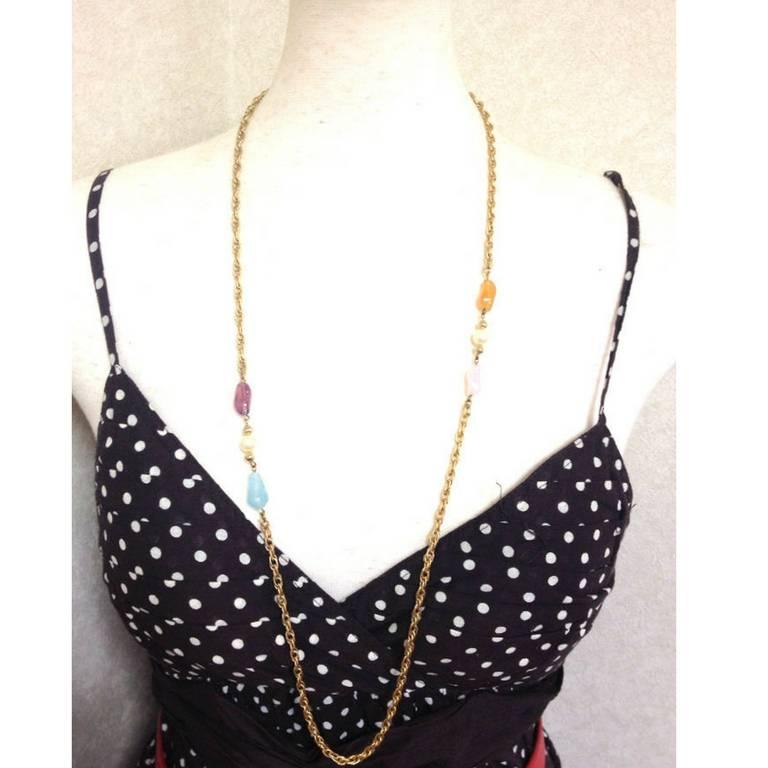 1990s. MINT. Vintage Givenchy, Paris, New York gold tone long chain necklace with purple, orange, pink, and blue stone motifs with 2 pearls. Can be double chain.

Introducing a MINT condition, vintage GIVENCHY long chain necklace approximately from