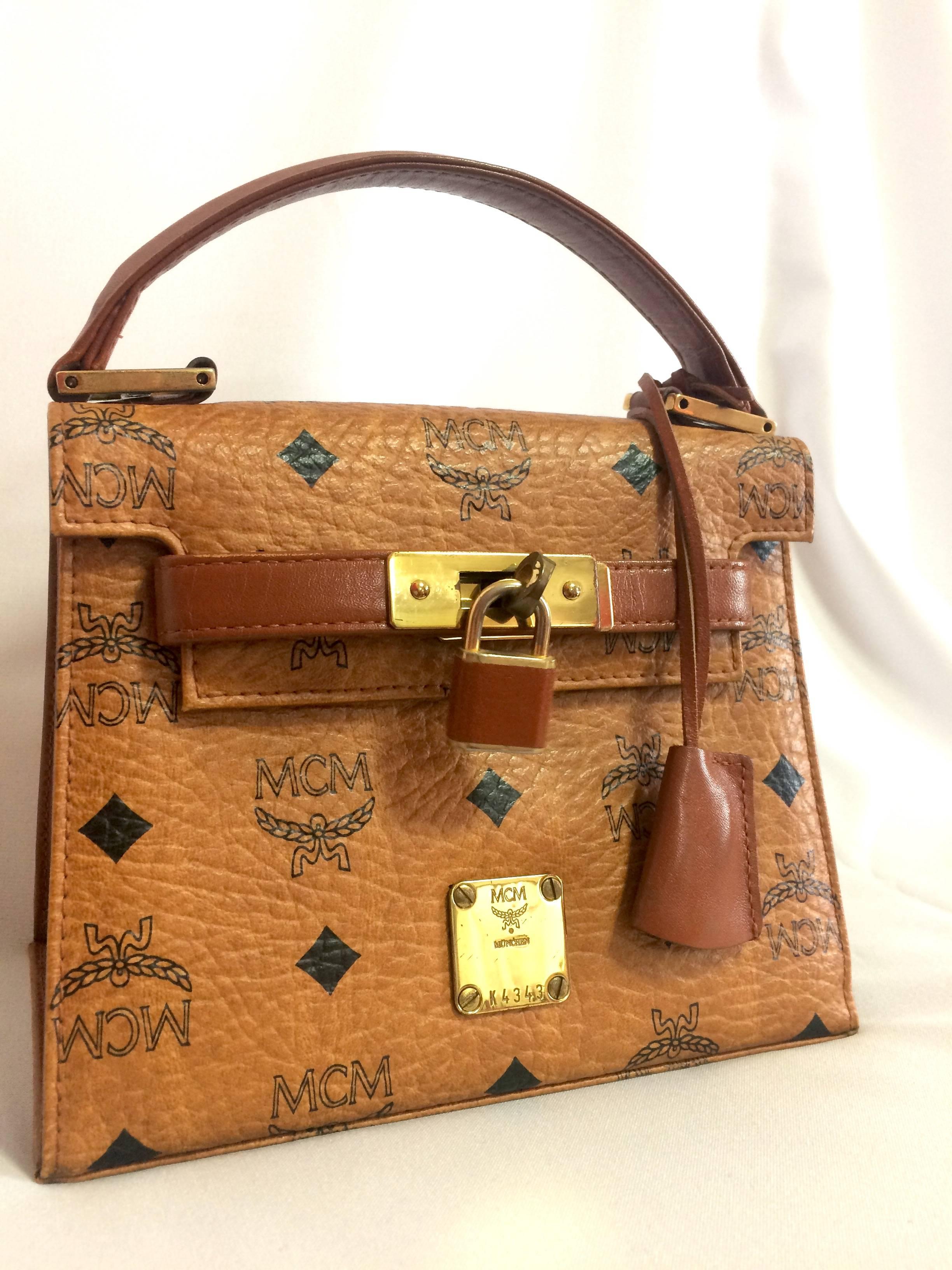 1990s. Vintage MCM classic brown monogram mini kelly bag with key, designed by Michael Cromer. Rare and beautiful masterpiece.

Introducing another rare and beautiful masterpiece from MCM, back in Michael Cromer production era,
Classic mini kelly