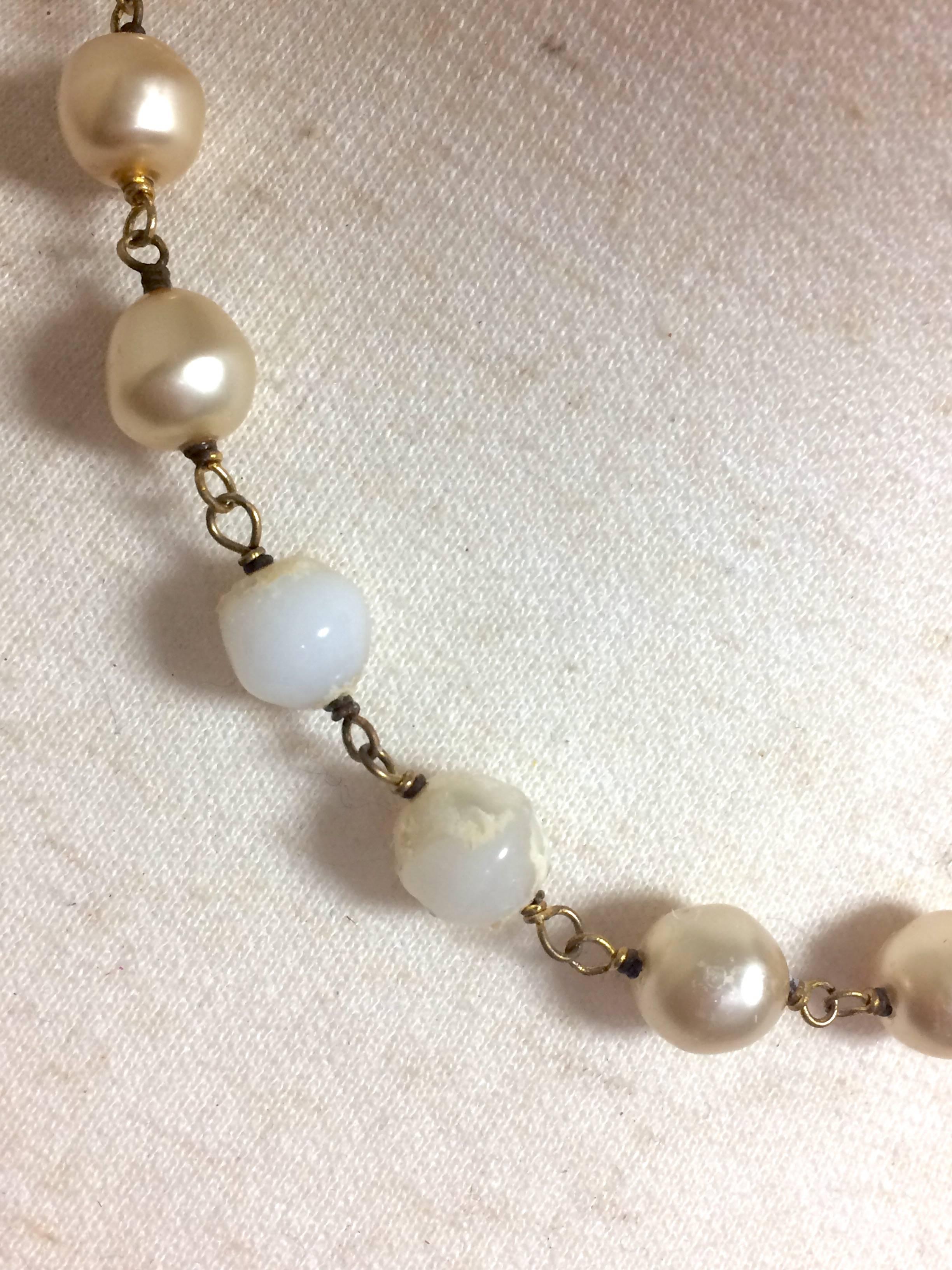 Women's Vintage CHANEL white cream faux baroque pearl necklace with CC mark pendant top.