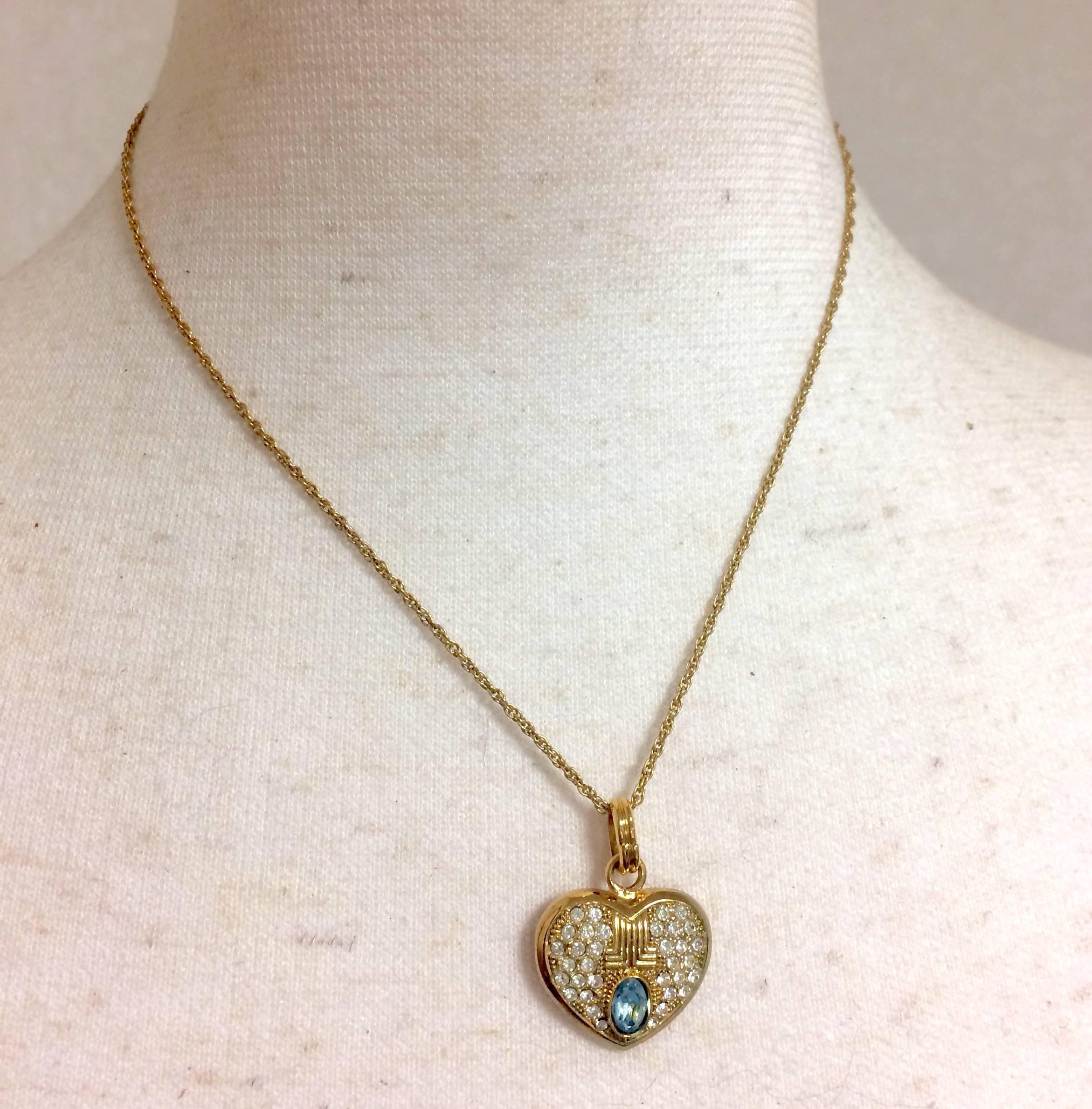 1980s. Vintage LANVIN golden skinny chain necklace with heart logo charm pendant top with clear crystals and blue crystal. Perfect jewelry gift.

This is a vintage gold-tone necklace with clear crystal and blue stone pendant top from LANVIN back in