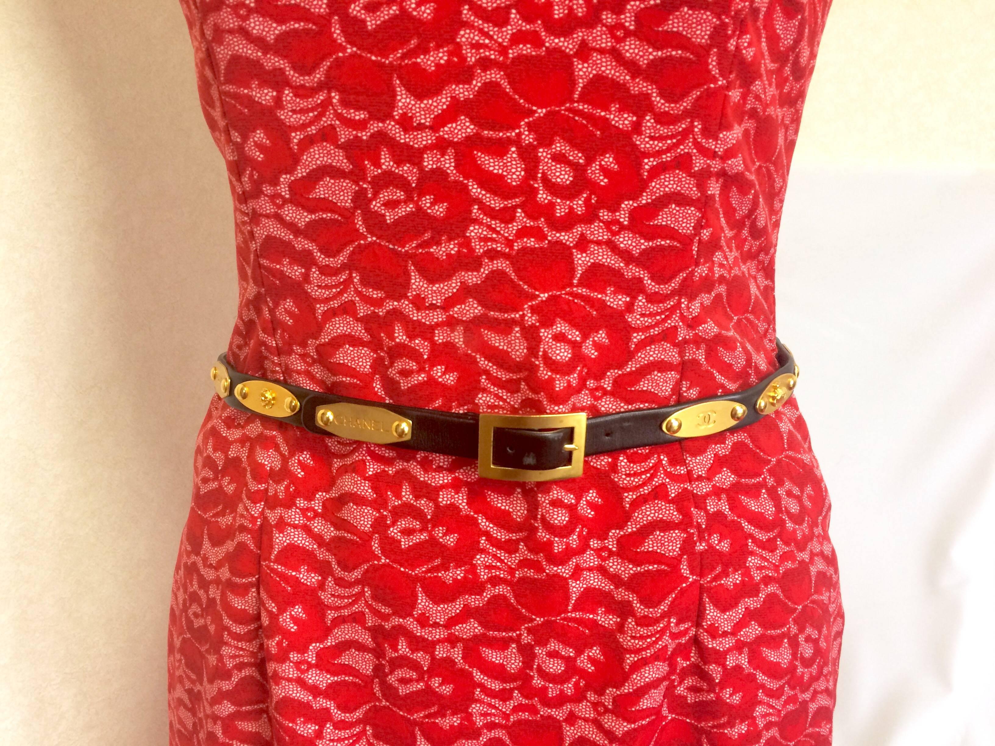 1990s. Vintage CHANEL black belt with golden buckle and iconic logo motifs, CC mark, camellia flower, turtle, perfume, clover. Must-have belt.

Here is another fabulous piece from CHANEL back in the mid 90's.
Introducing a black leather skinny belt