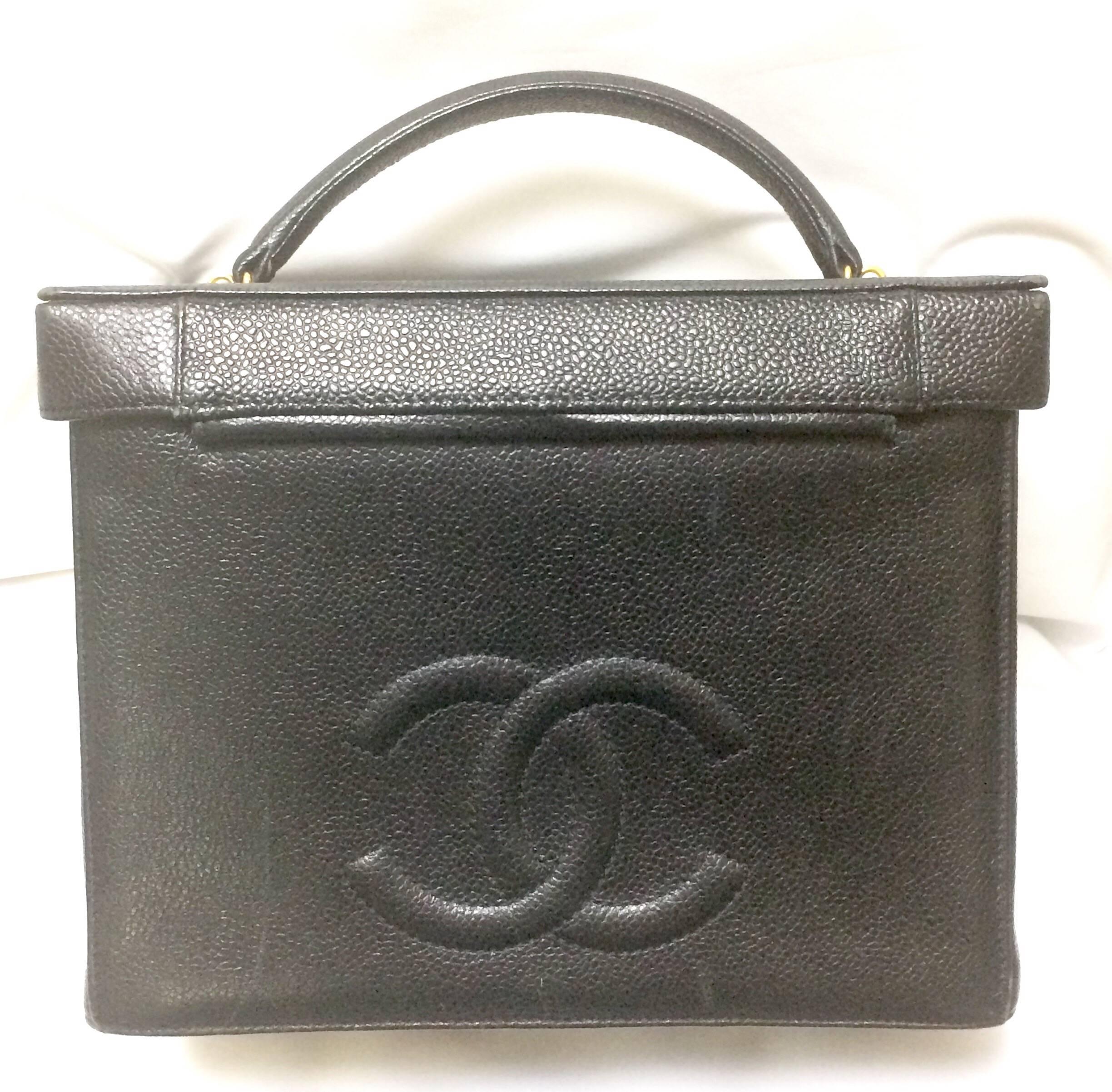 1990s. Vintage CHANEL black caviar leather large vanity purse, lunchbox style handbag. Can be cosmetic case, daily use bag. Lady Gaga's favorite.


Introducing a vintage CHANEL black caviar leather large vanity bag, handbag with golden round CC