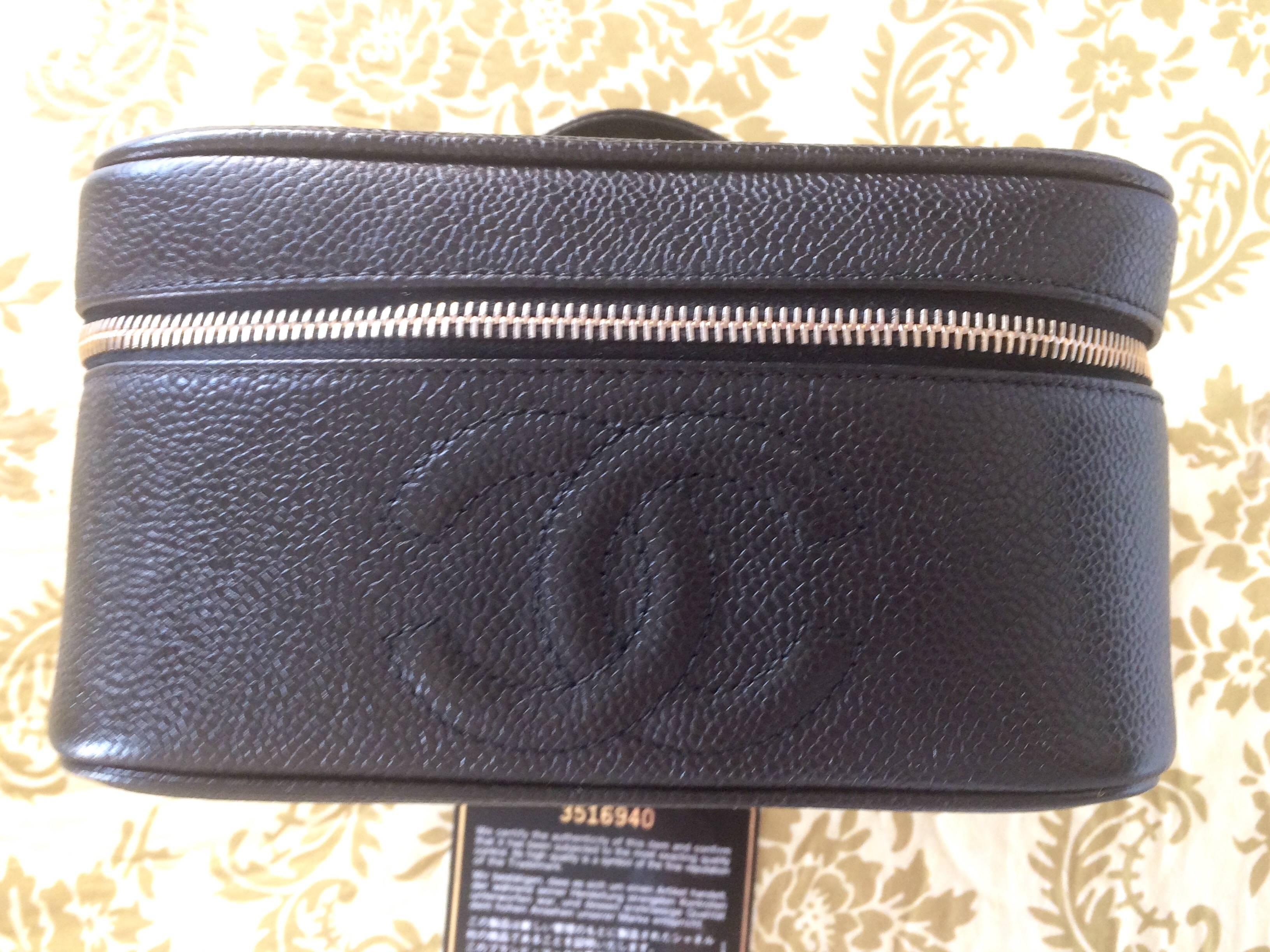 1990s. Vintage CHANEL black caviar leather cosmetic and toiletry bag, party vanity purse with large CC stitch mark. Very chic and classic pouch.
Introducing another classic vintage piece from CHANEL.... cosmetic bag, party vanity purse, mini handbag